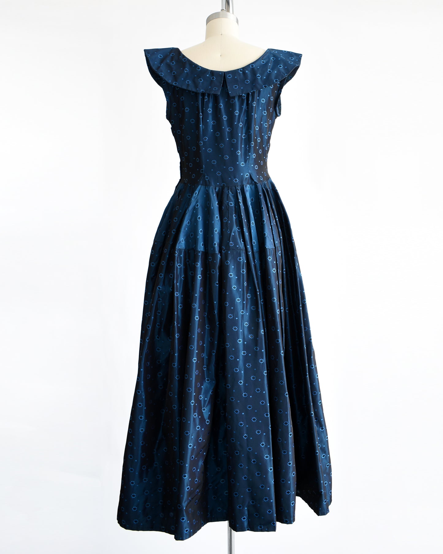 back view of a vintage 1950s blue black floral brocade dress