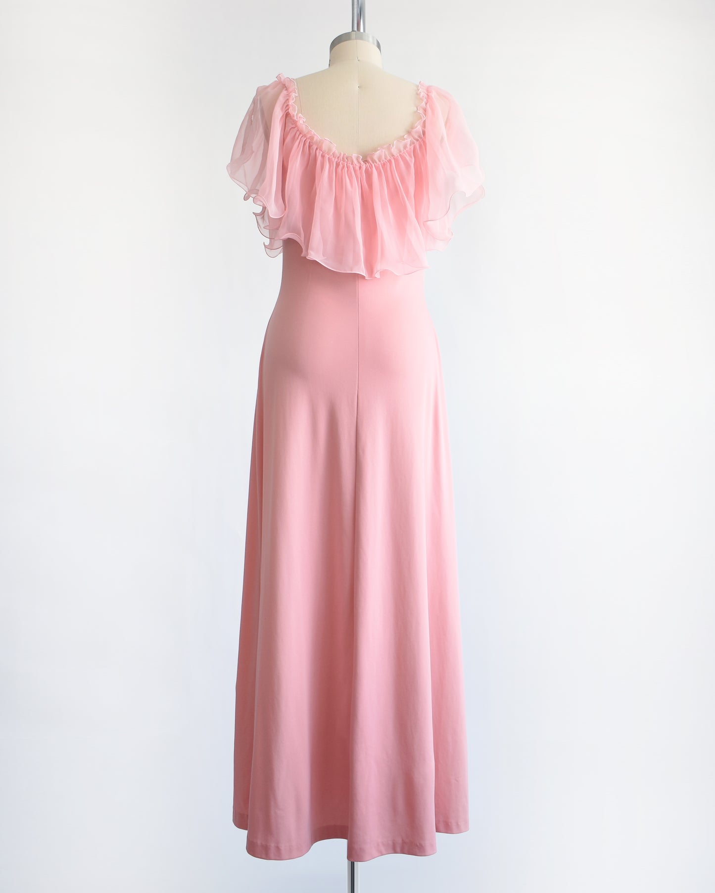 back view of a vintage 1970s pink flutter maxi dress