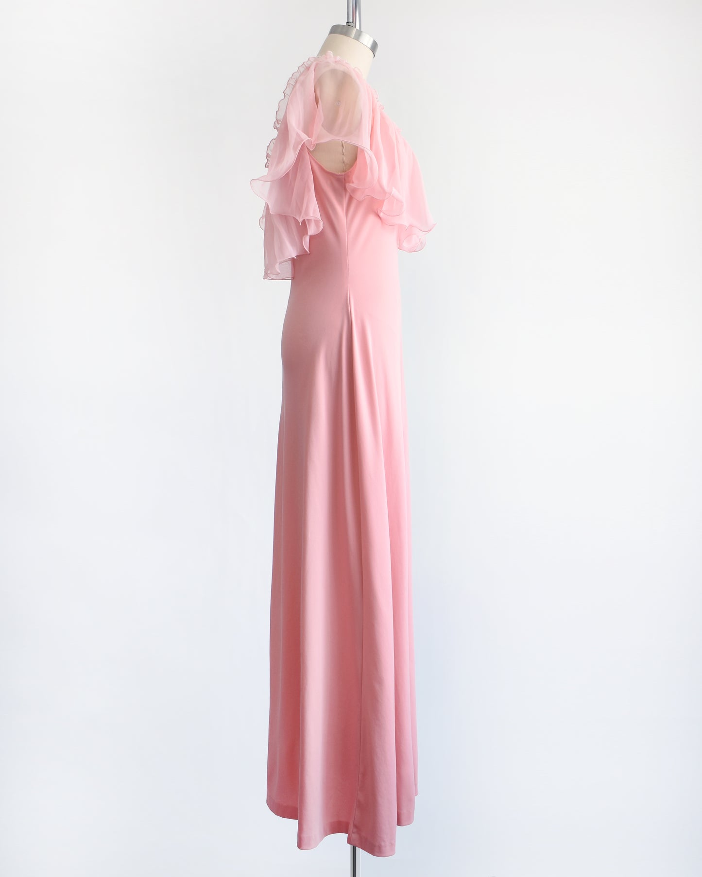 side view of a vintage 1970s pink flutter maxi dress