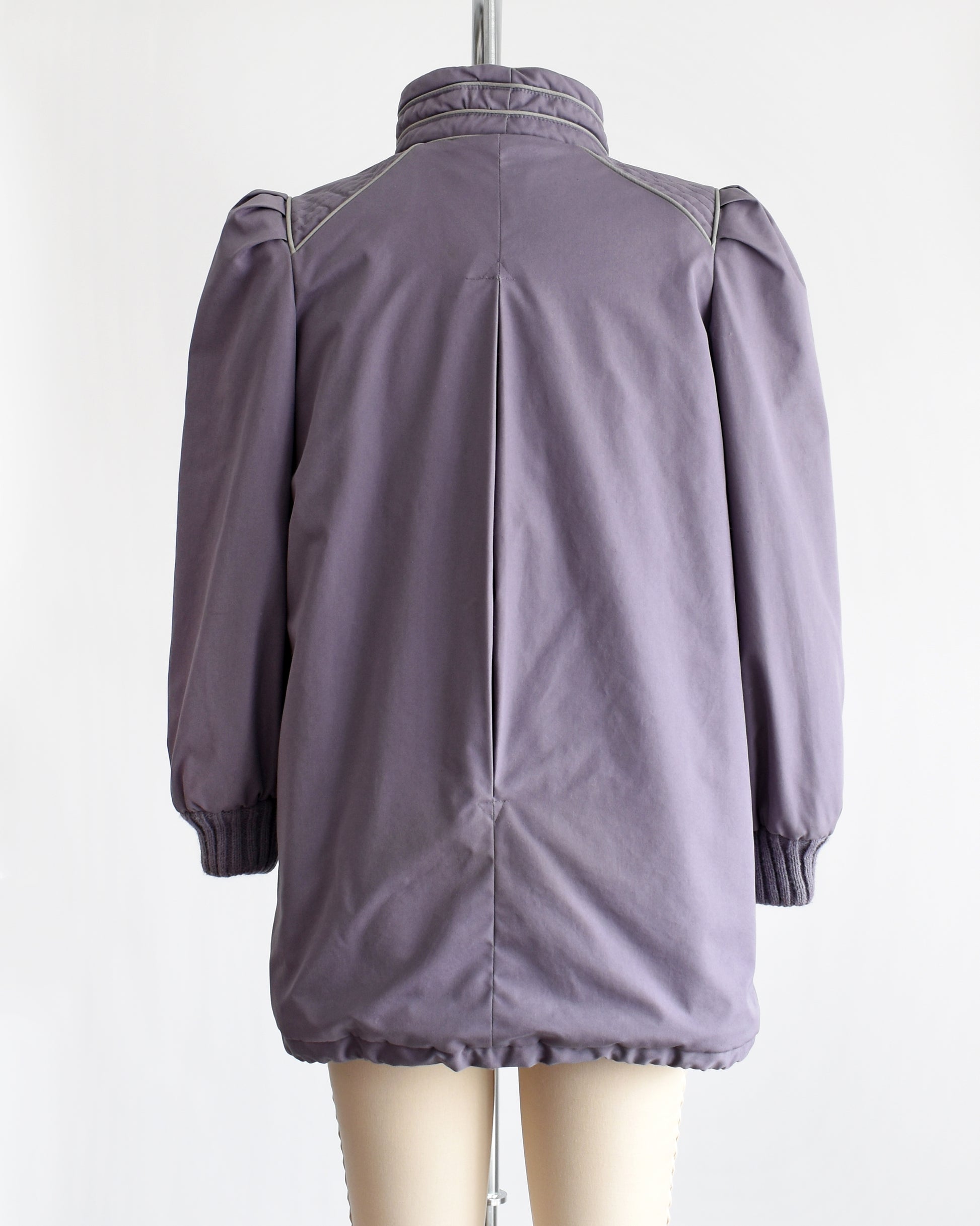 Back view of a vintage 1980s purple puffy coat with shawl style collar with gray trim