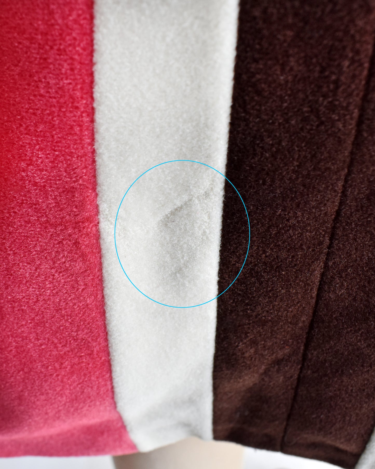 a close up of a spot of fabric that is missing on the robe near the hem