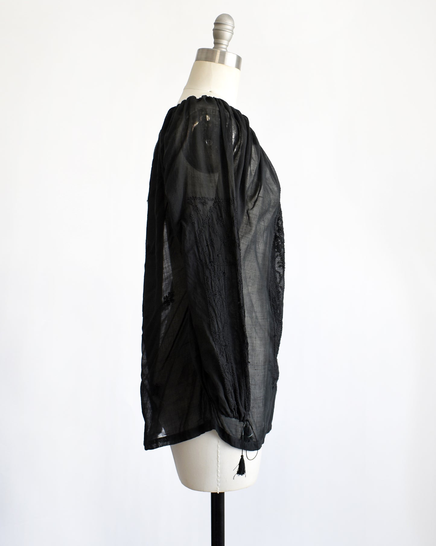 side view of a vintage 1970s black embroidered blouse by Kaiser