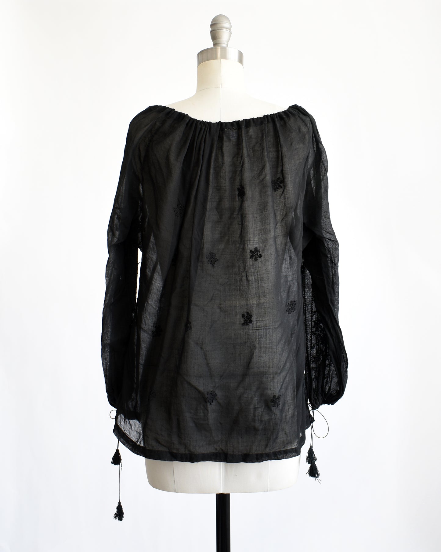 back view of a vintage 1970s black embroidered blouse by Kaiser
