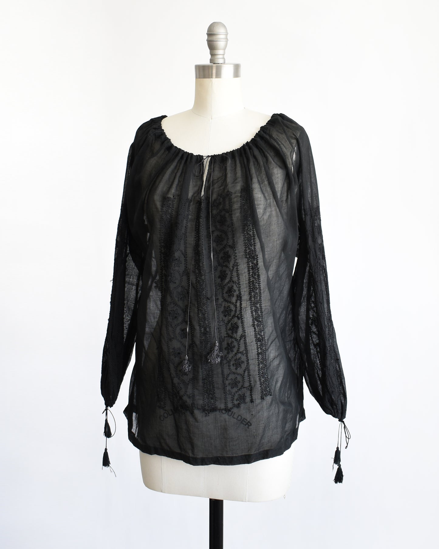 side front view of a vintage 1970s black embroidered blouse by Kaiser
