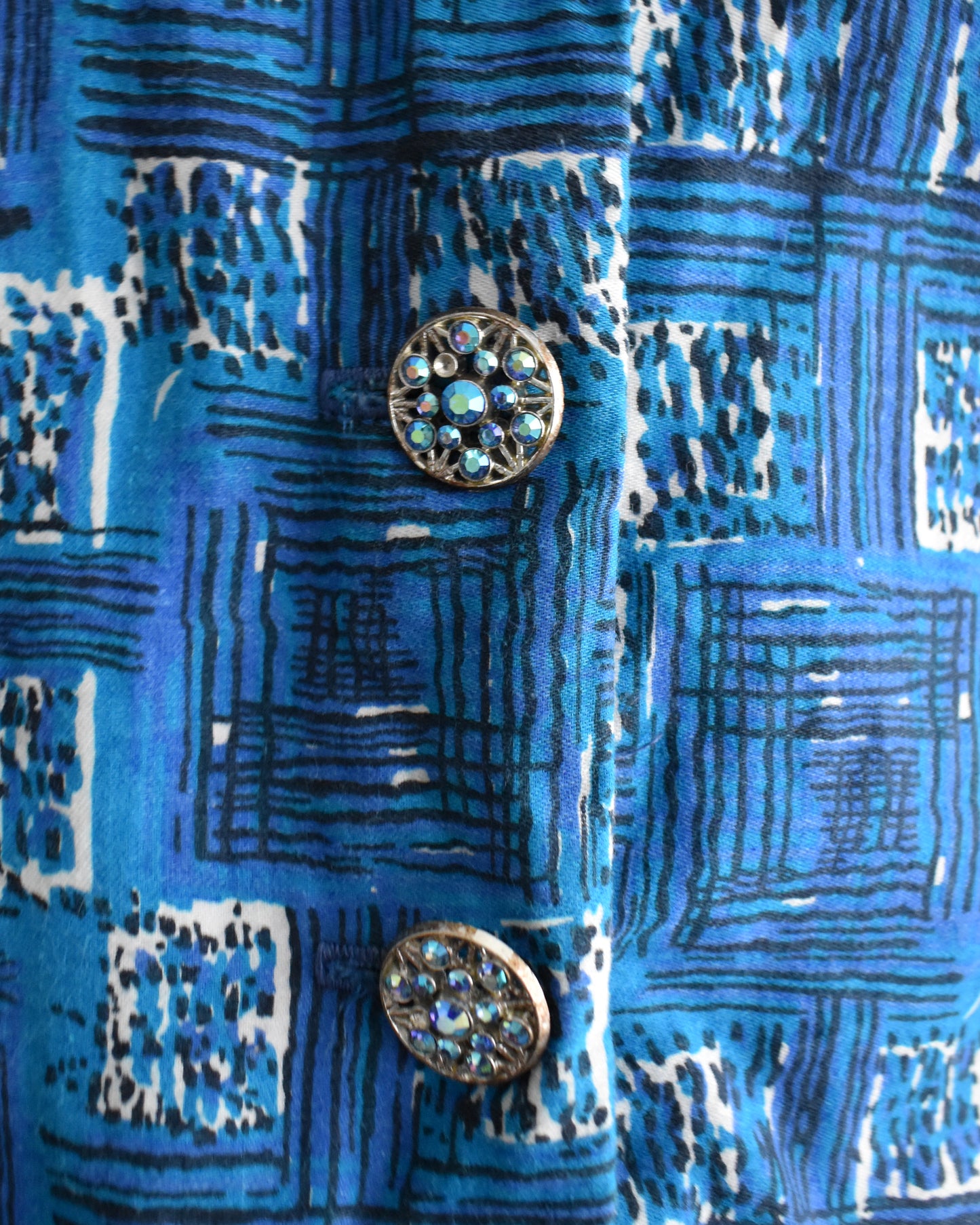 close up of the rhinestone buttons on the dress