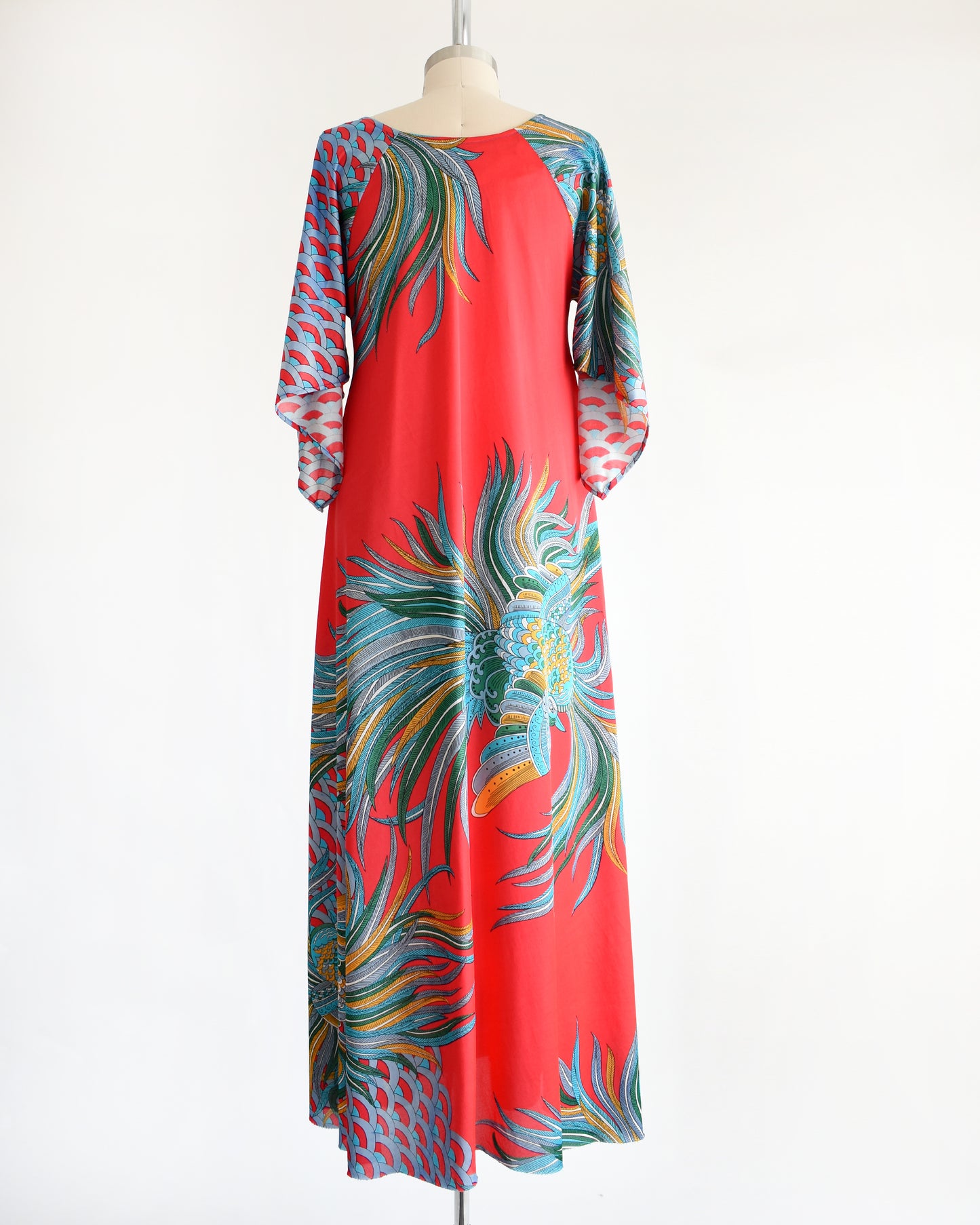 back view of a vintage 1970s red and blue psychedelic bird caftan