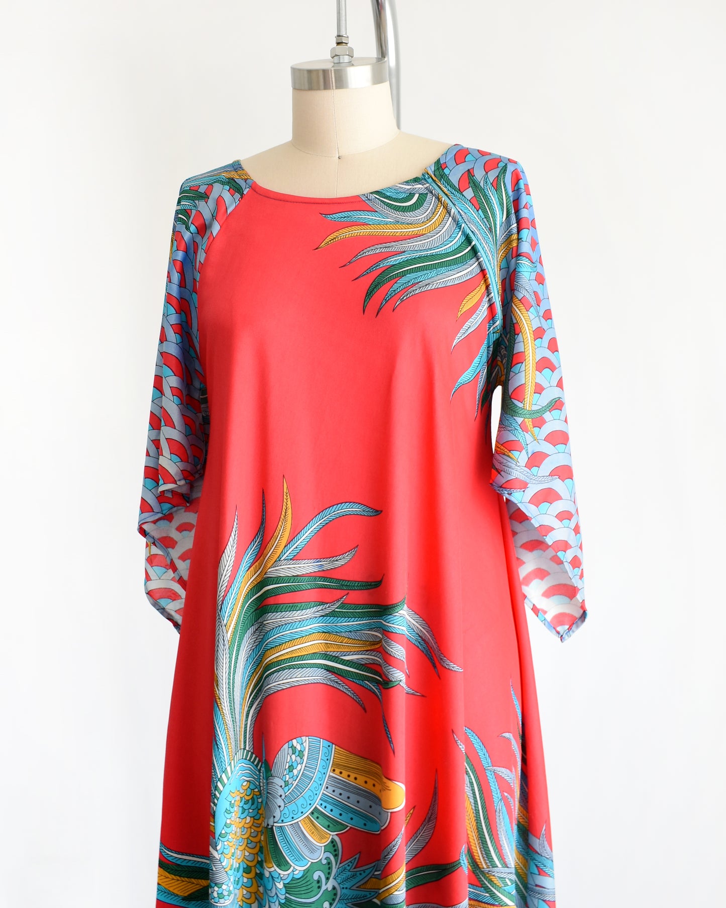 side front view of a vintage 1970s red and blue psychedelic bird caftan
