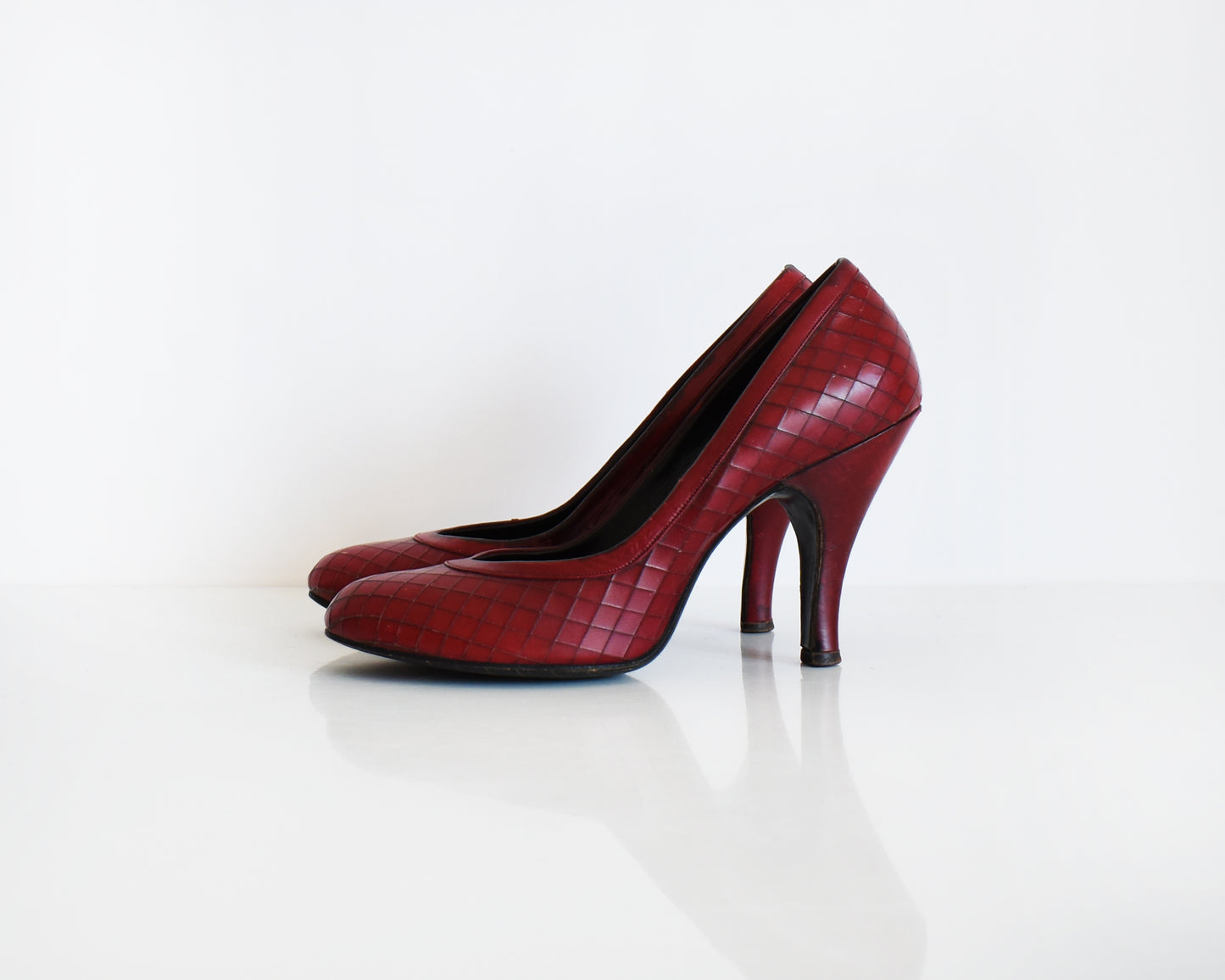a pair of vintage 1960s burgundy criss-cross pattern high heels
