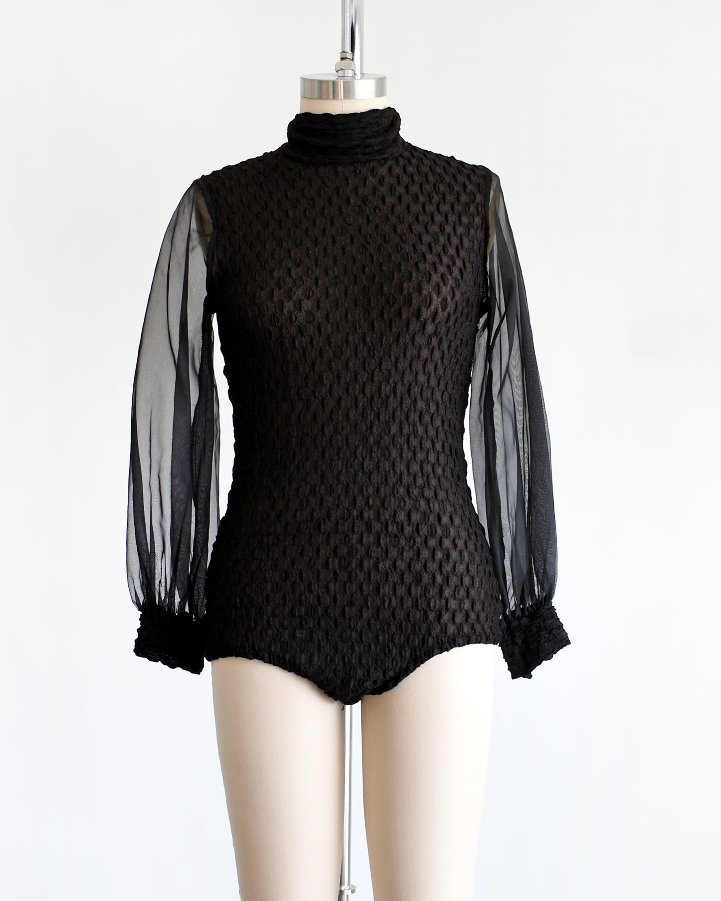 a vintage 1970s black textured bodysuit with long sleeves