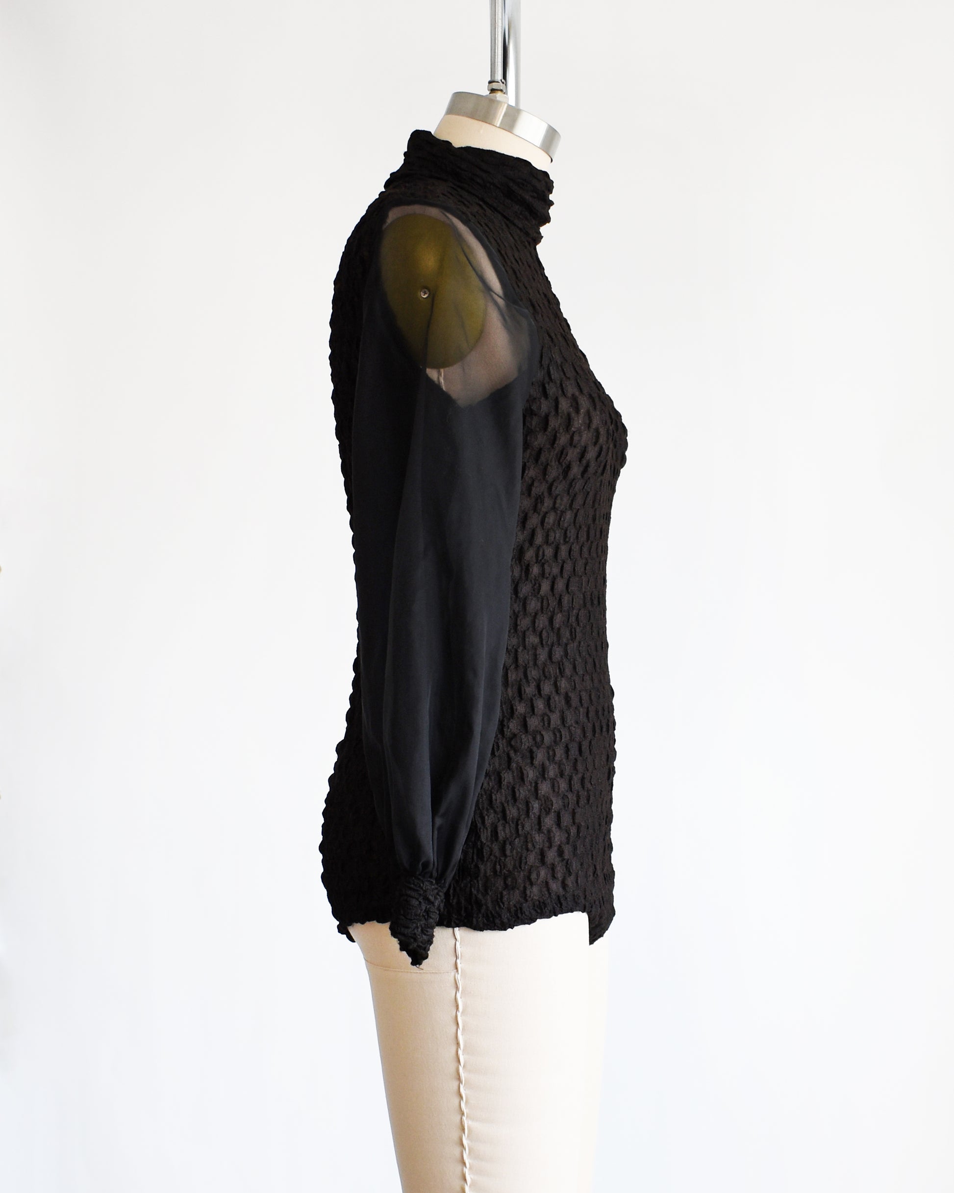 side view of a vintage 1970s black textured bodysuit with long sleeves
