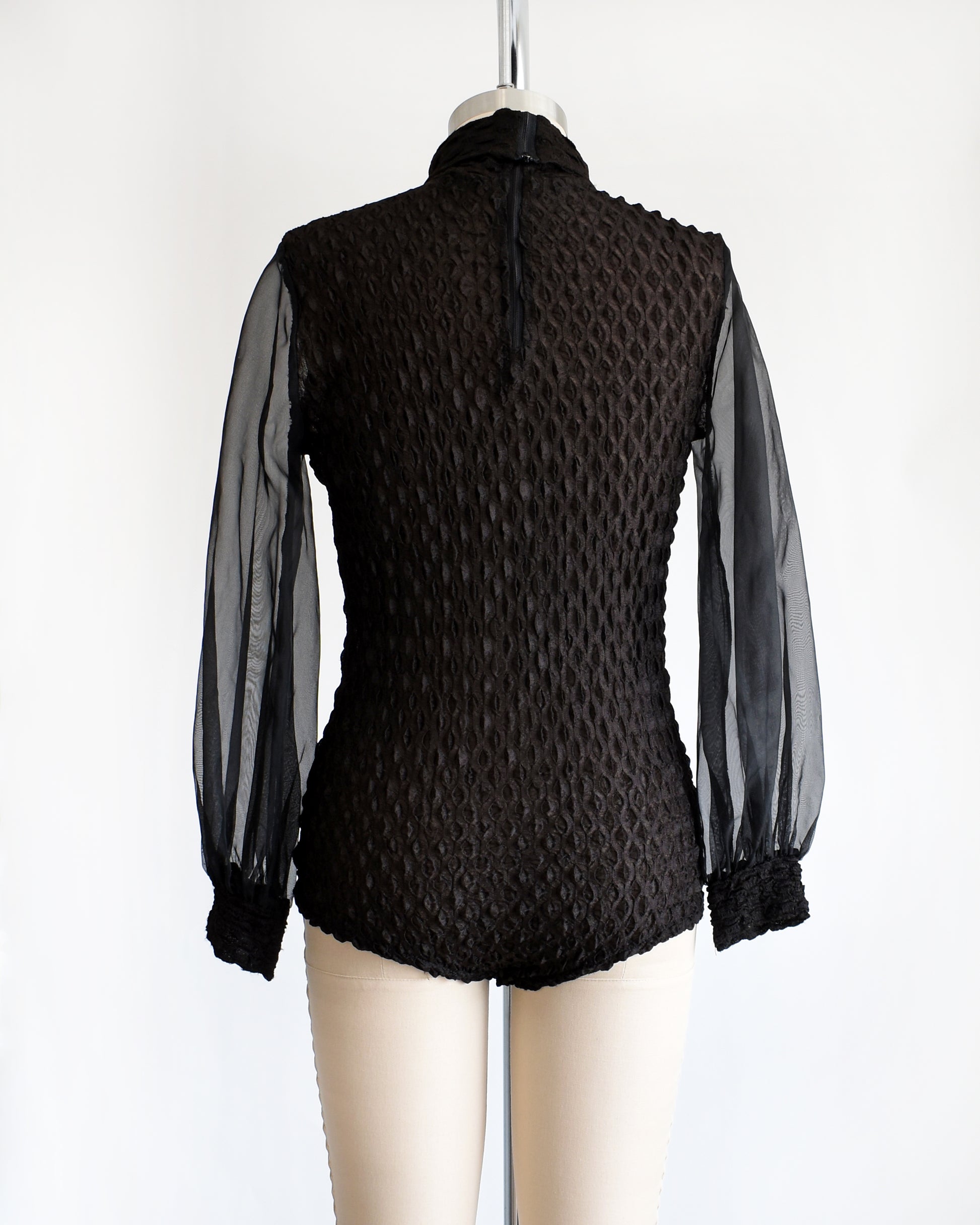 back view of a vintage 1970s black textured bodysuit with long sleeves