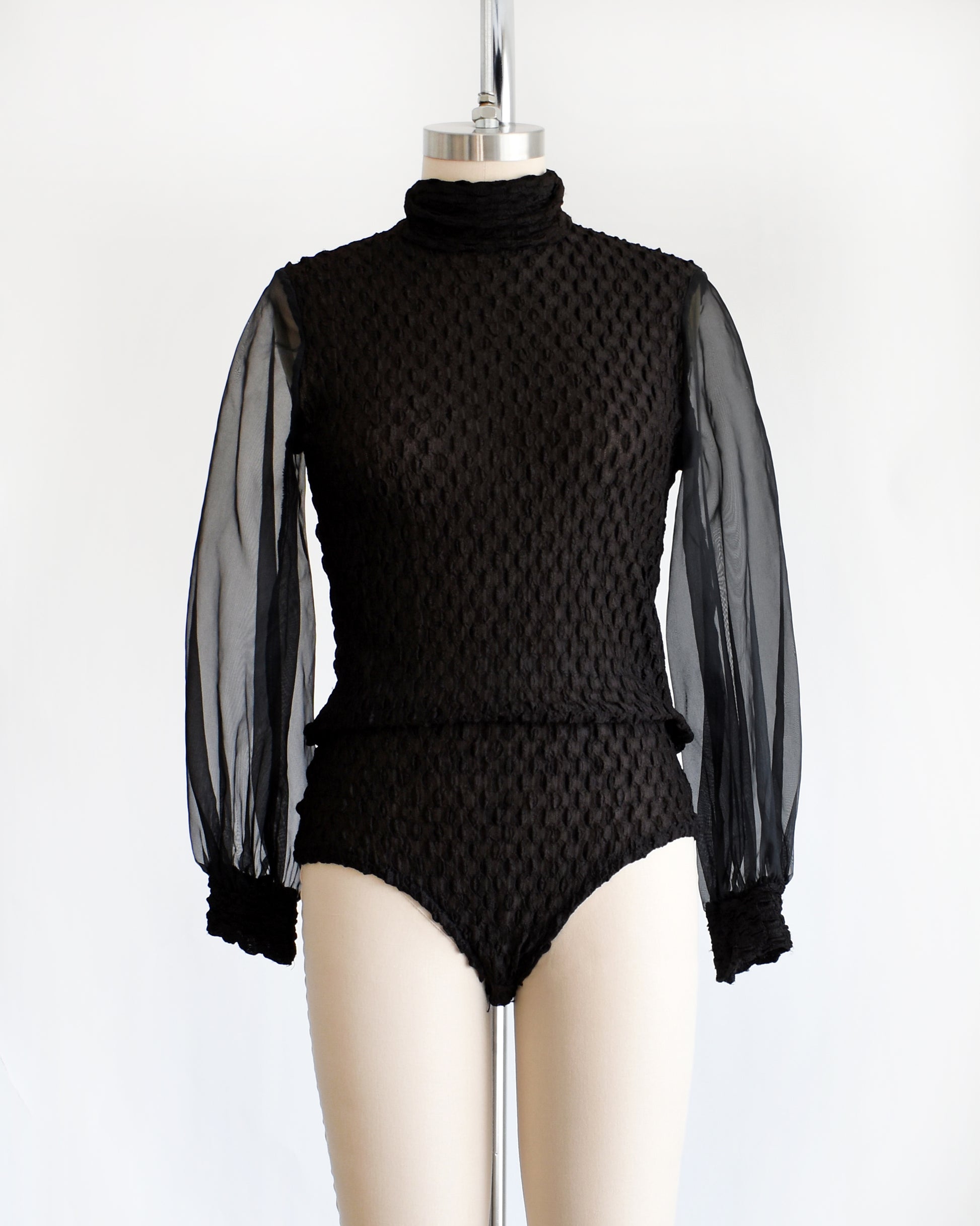 a vintage 1970s black textured bodysuit with long sleeves