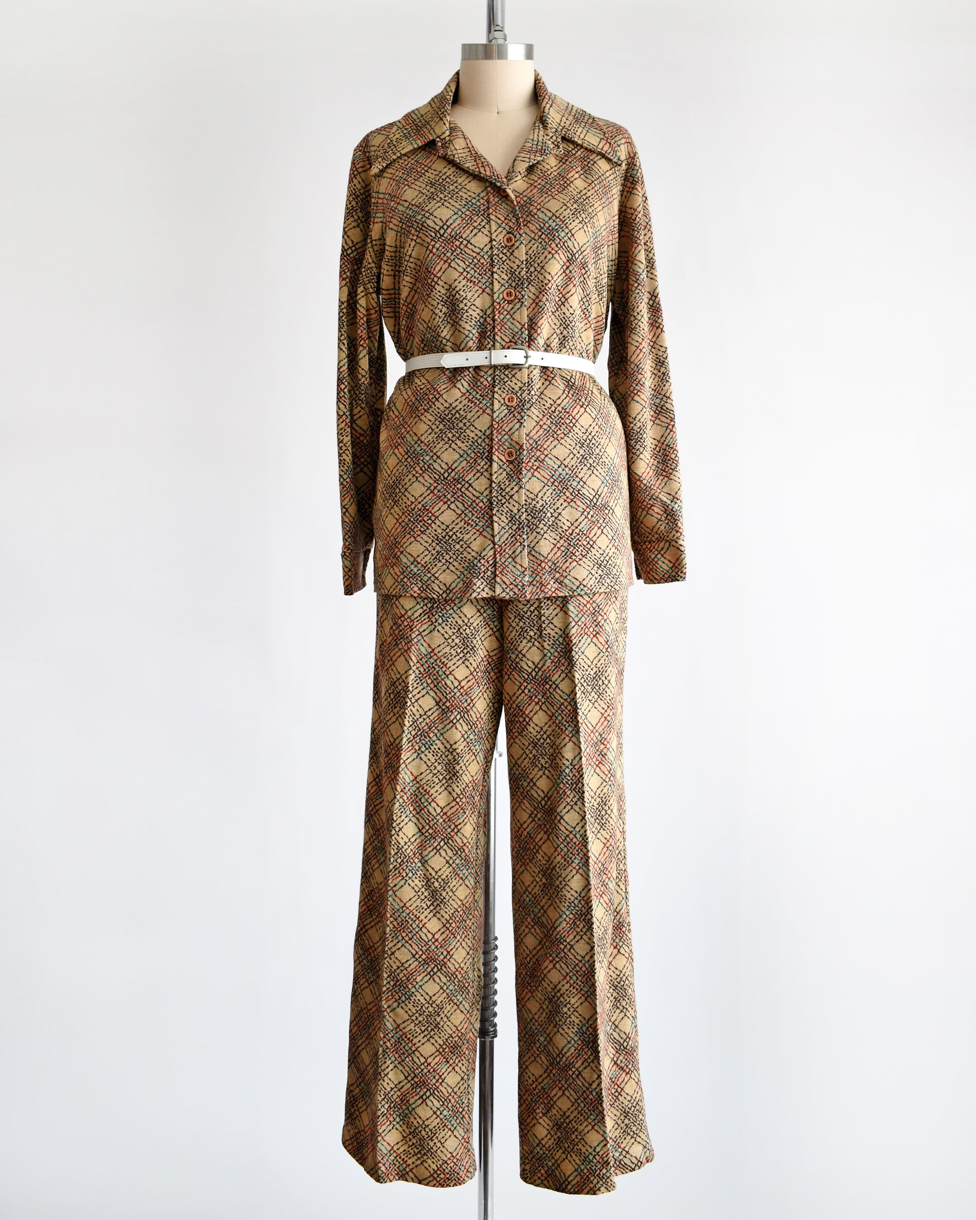 a vintage 1970s brown plaid pantsuit with a decorative white belt