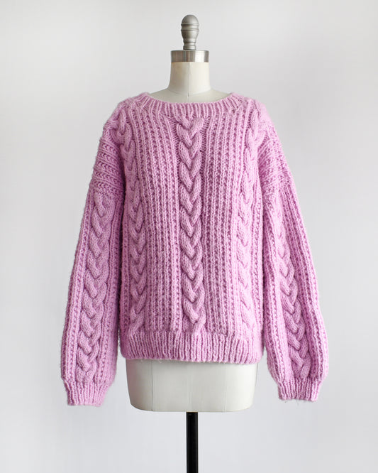a vintage 1980s chunky purple pink cable knit sweater