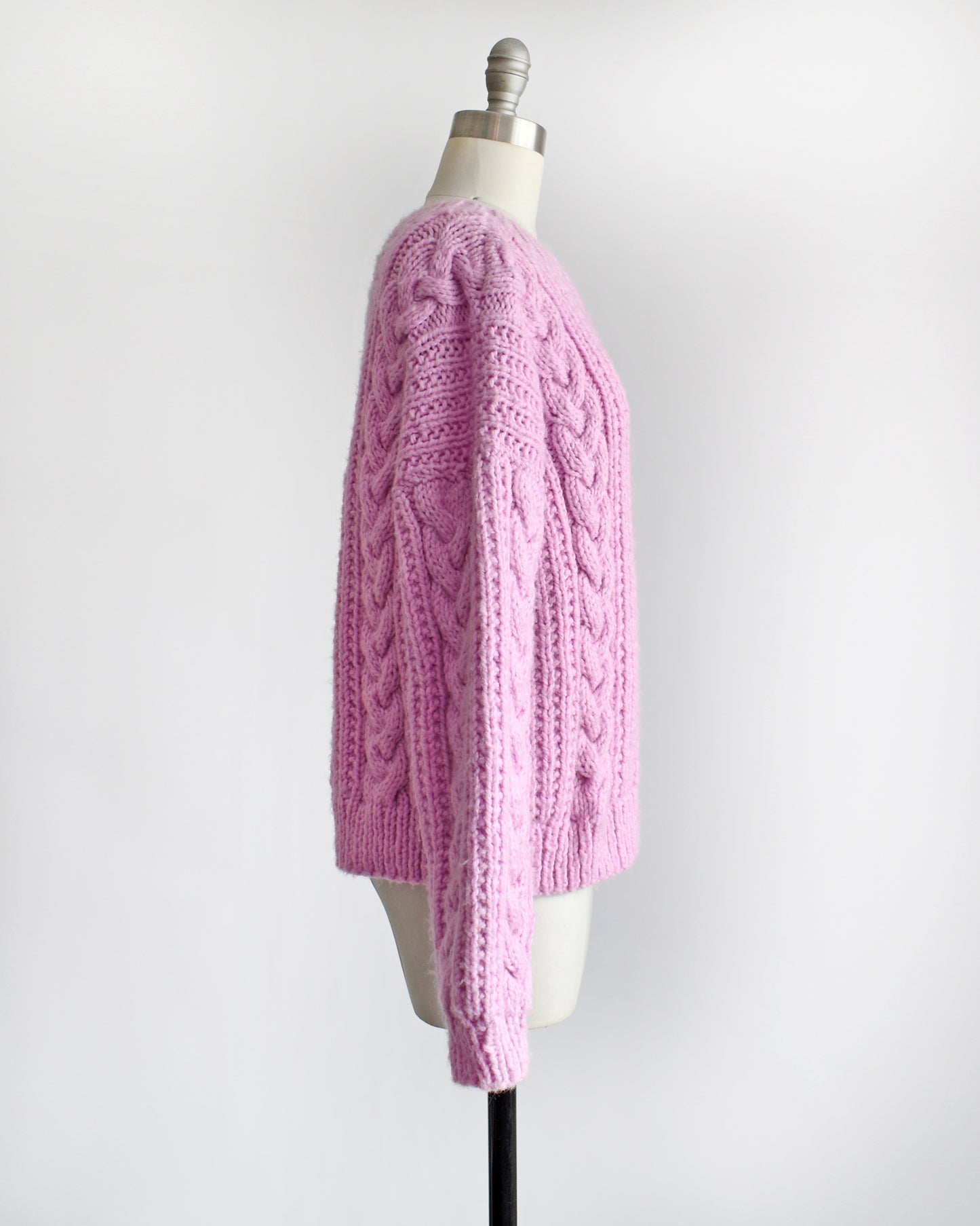 side view of a vintage 1980s chunky purple pink cable knit sweater
