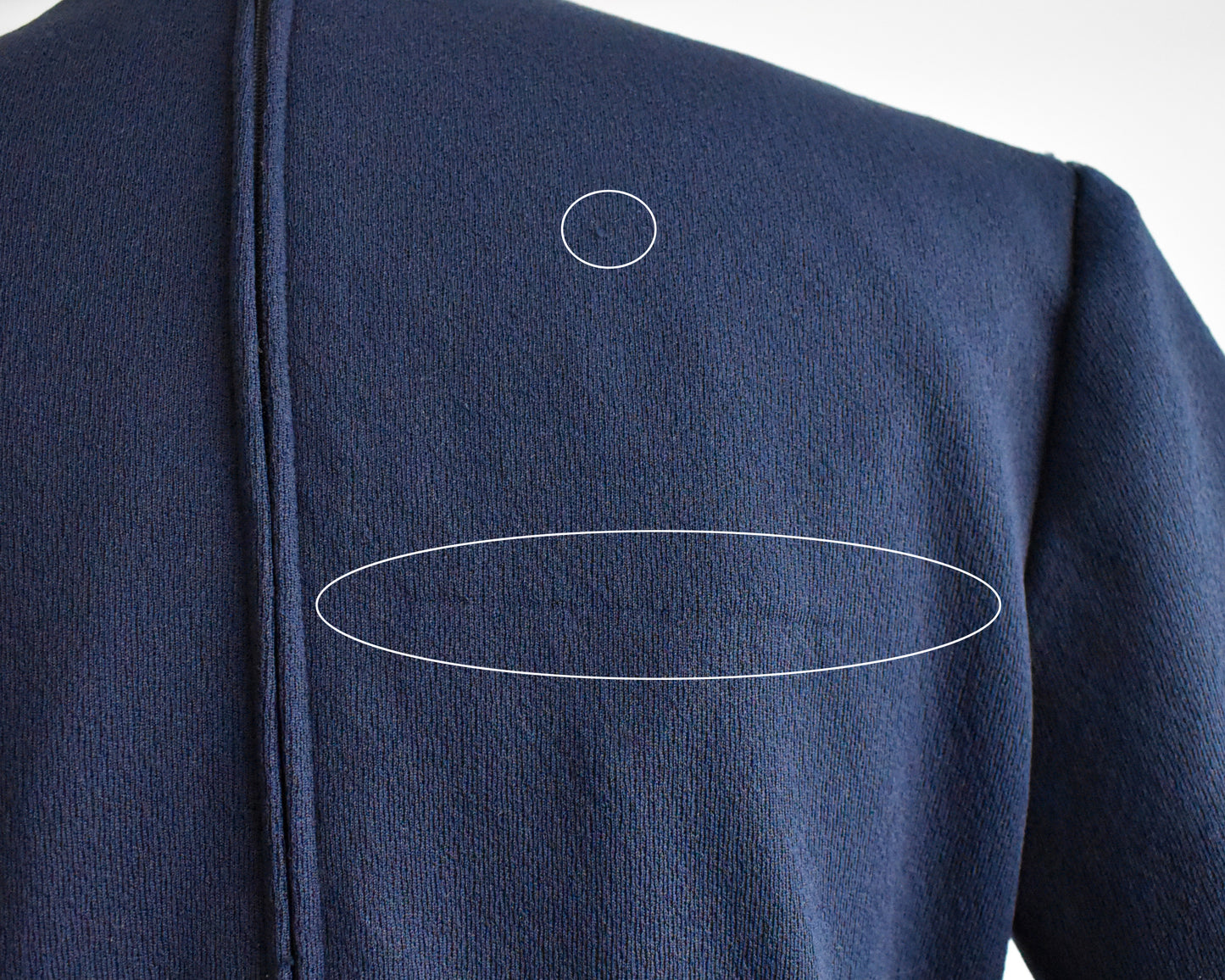 A close up of the right back shoulder area that has a few snags and pulls