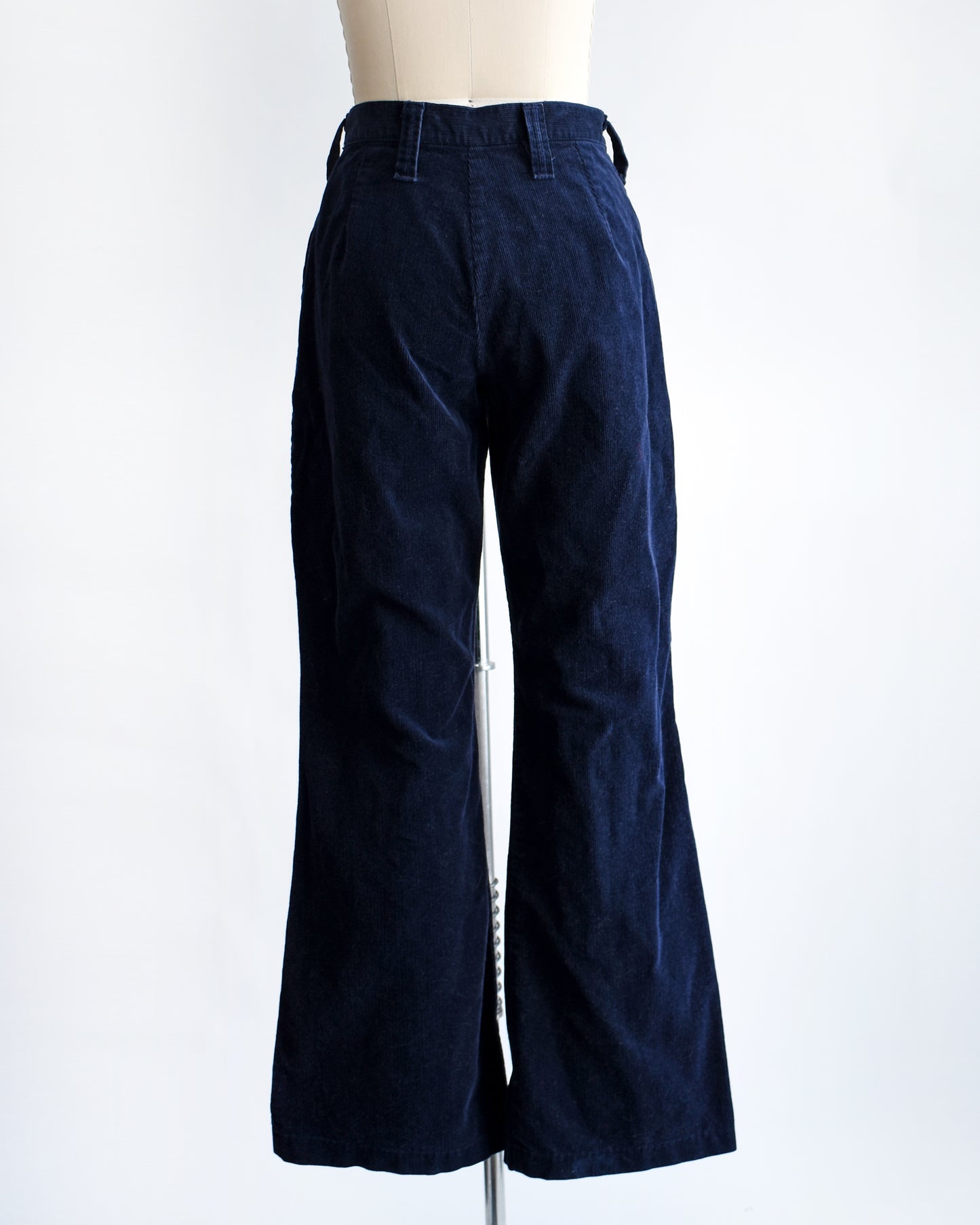 back view of a pair of vintage 1970s navy blue corduroy bell bottoms by Lady Wrangler