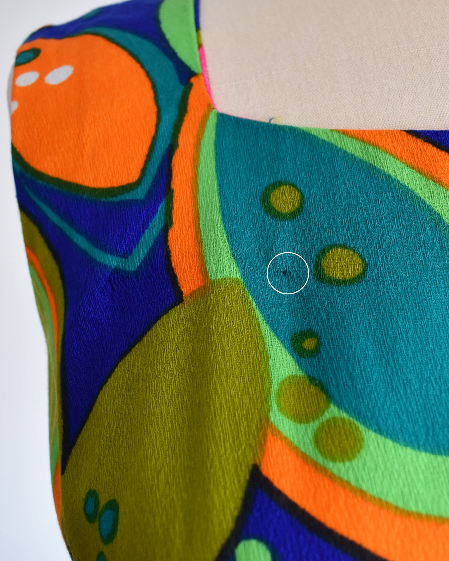 close up of the a small snag in the weave on the upper right shoulder area