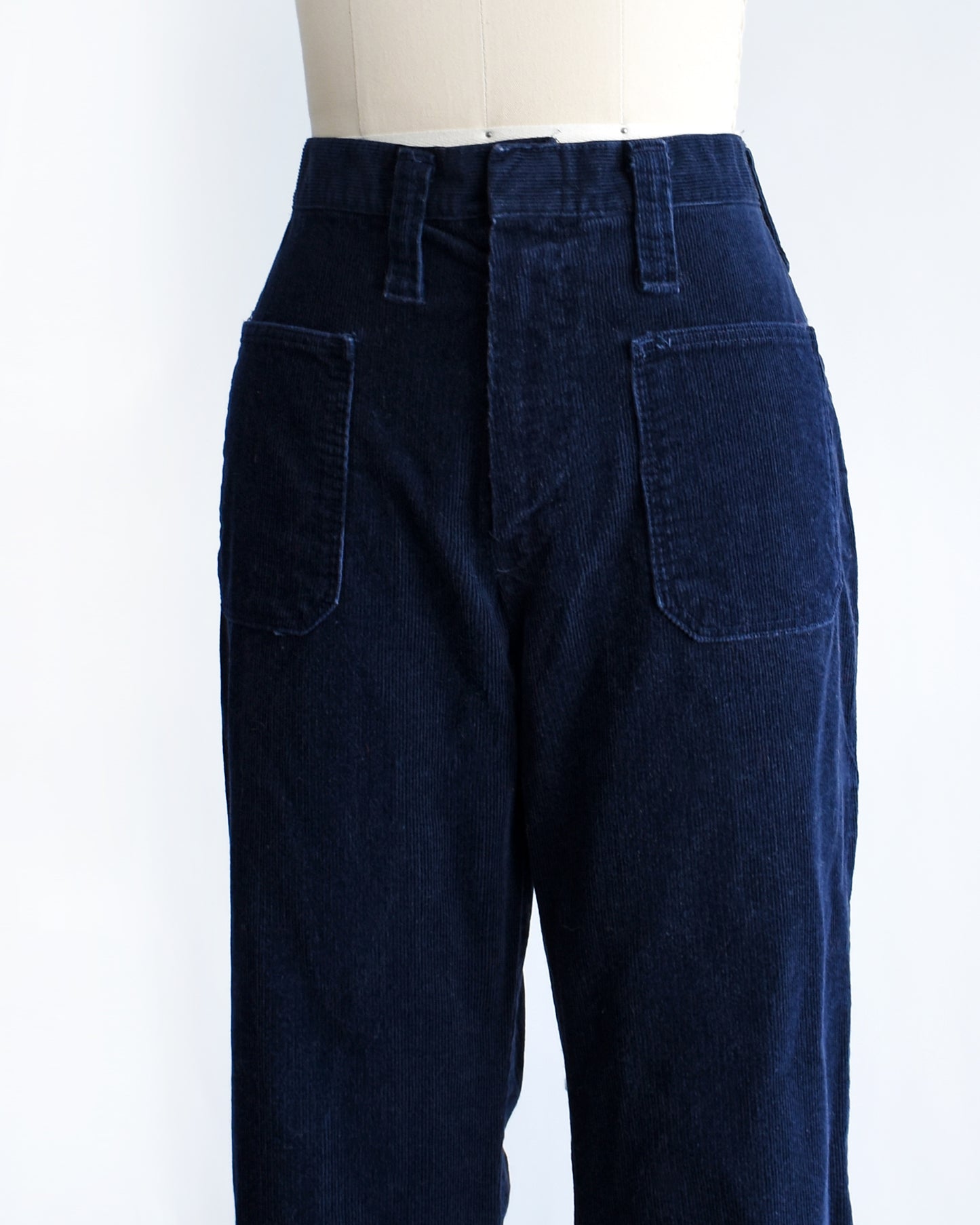 side front view of a pair of vintage 1970s navy blue corduroy bell bottoms by Lady Wrangler