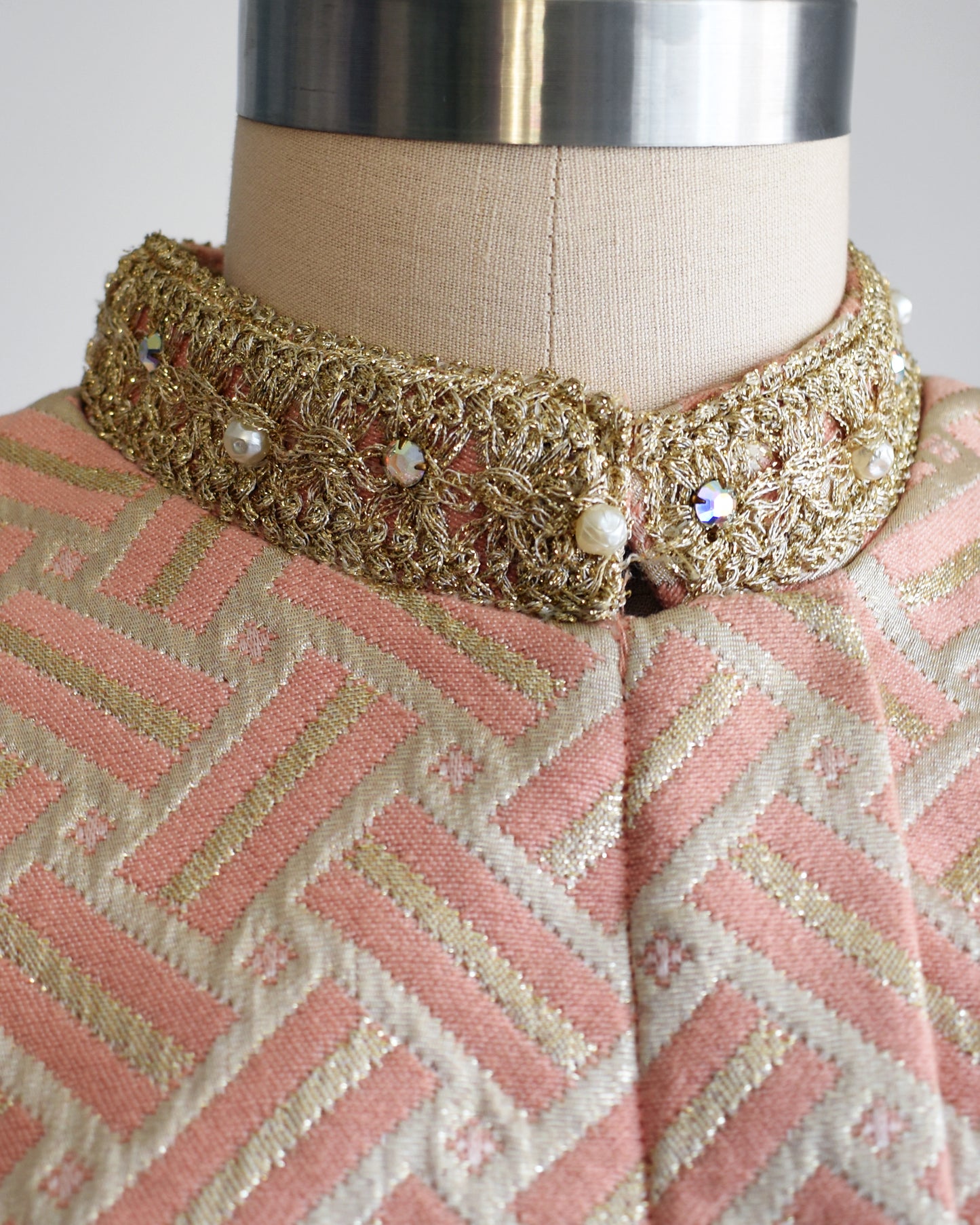 Close up of the metallic gold trim and rhinestones around the neck