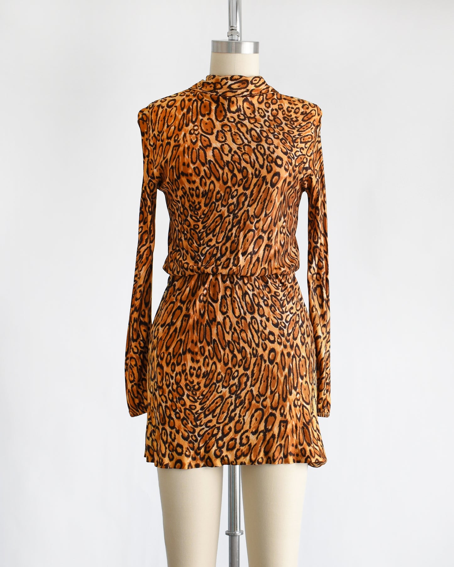 a vintage 1960s leopard print mini dress. the dress is pulled up via the elastic waist.