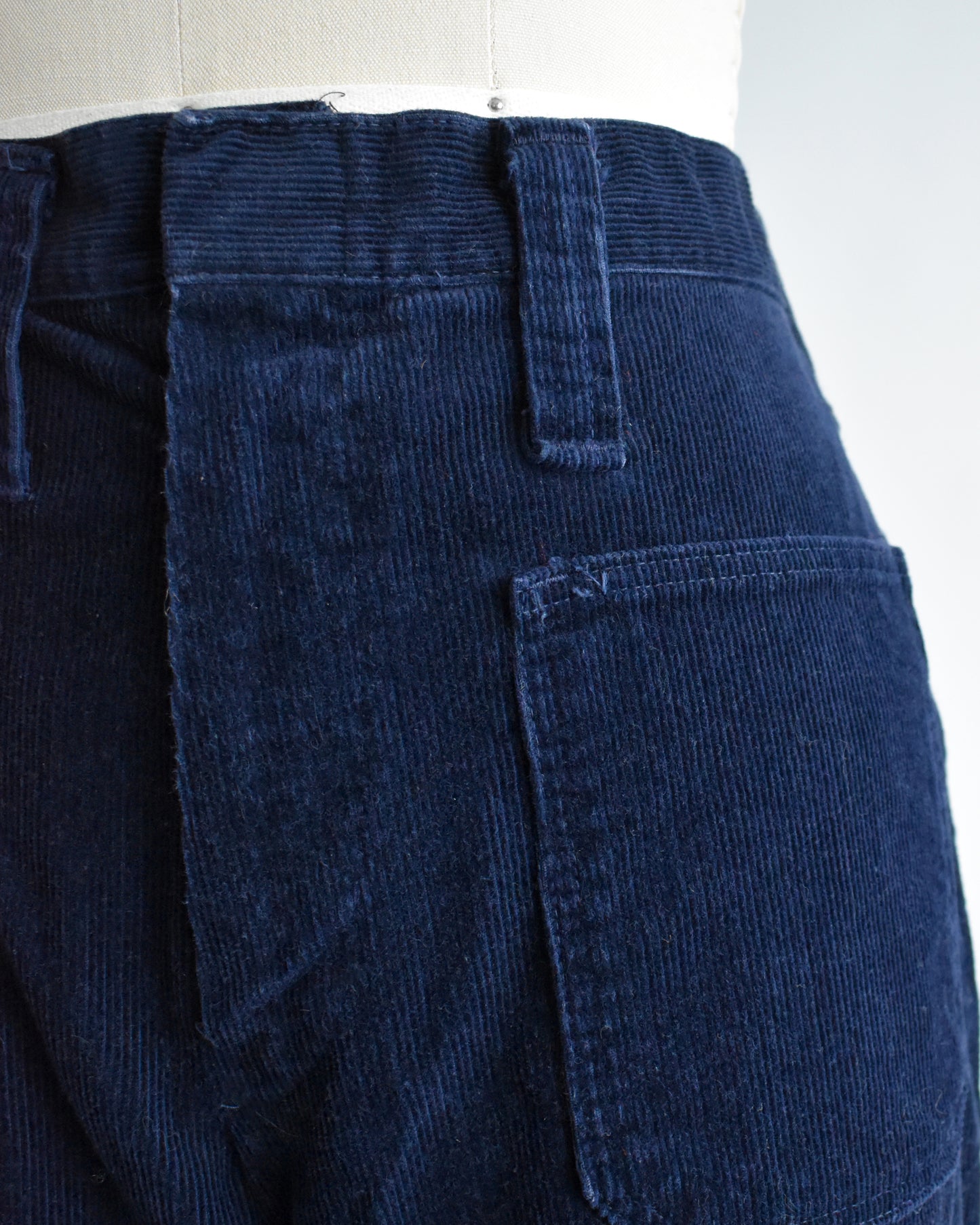 close up of the waist of a pair of vintage 1970s navy blue corduroy bell bottoms by Lady Wrangler