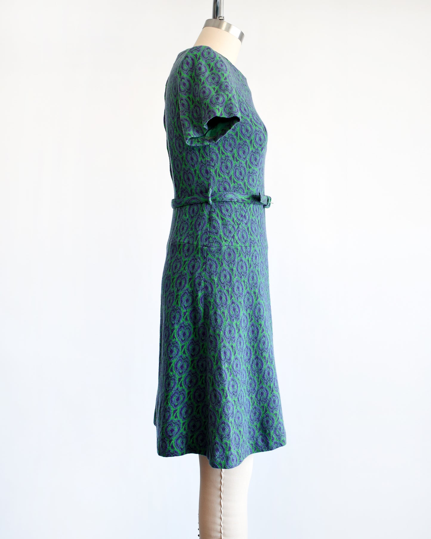 side view of a vintage 1960s green and purple drop waist dress and matching belt