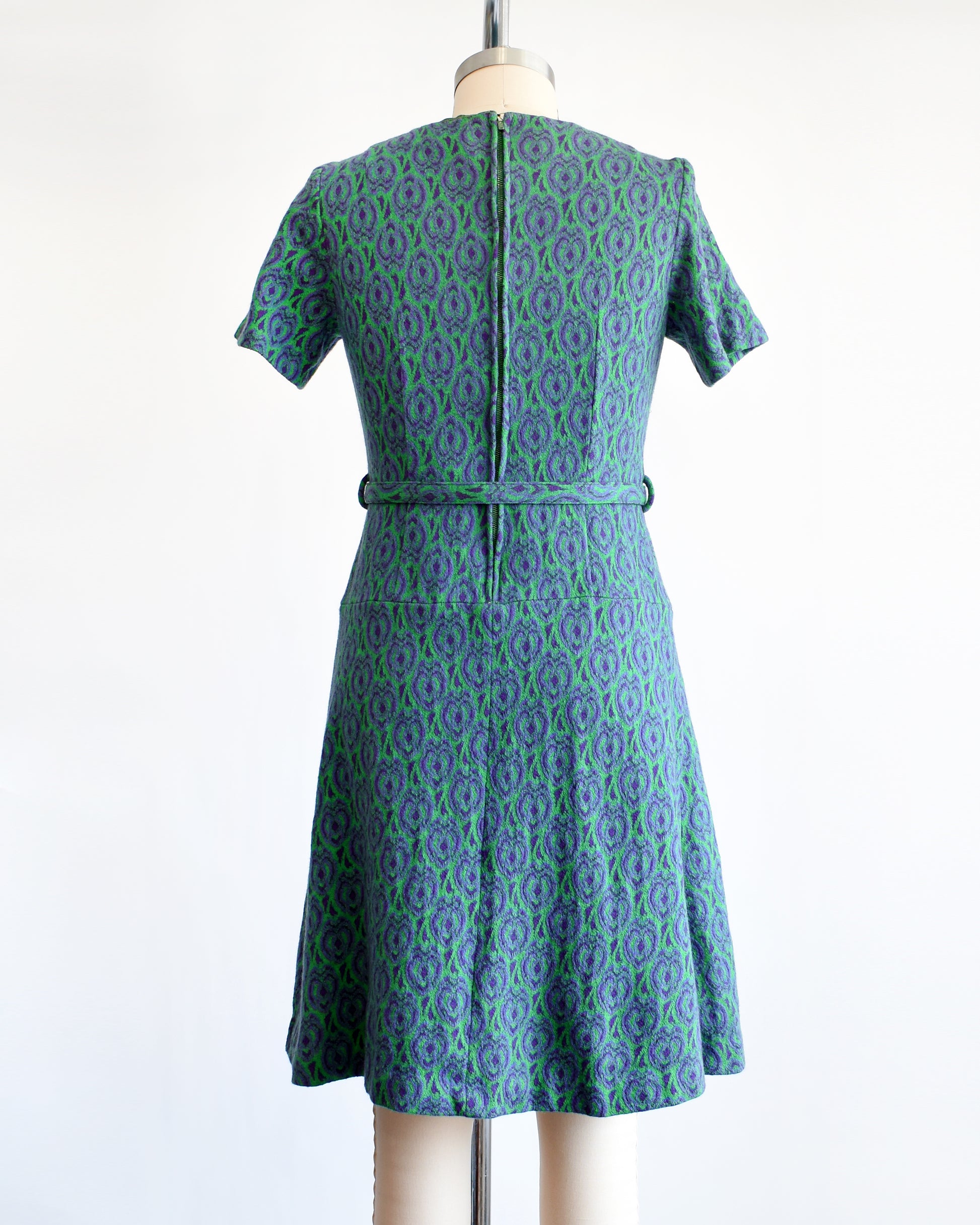 back view of a vintage 1960s green and purple drop waist dress and matching belt