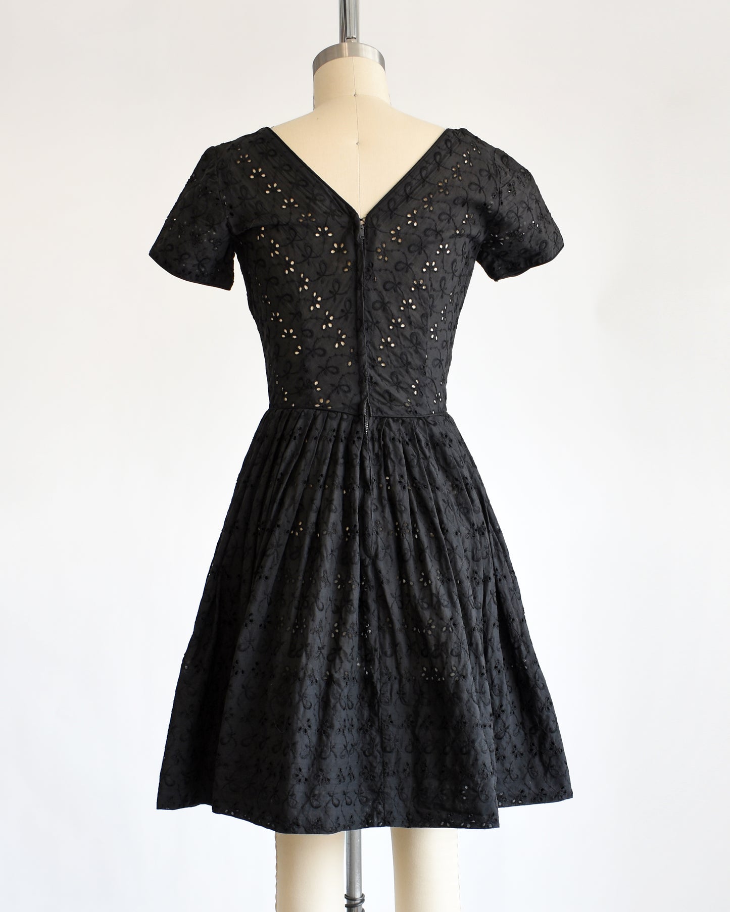 back view of a late 1950s early 1960s vintage black eyelet dress