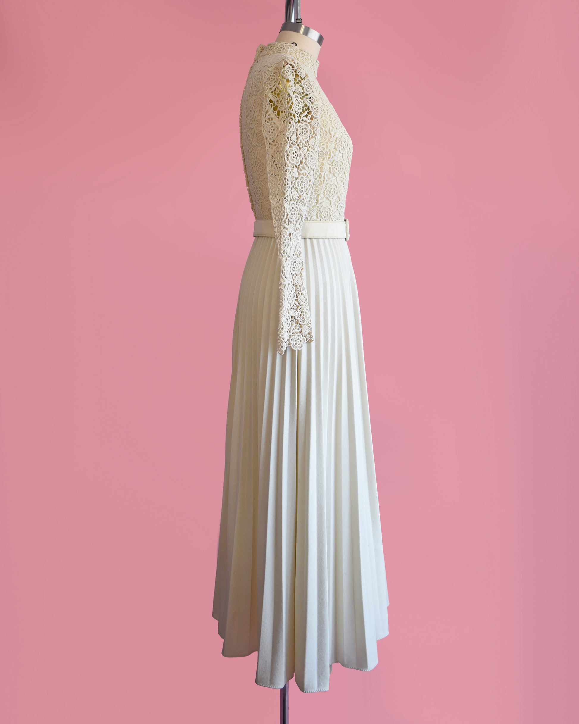 side view of a vintage 1970s crochet floral lace pleated maxi dress with matching belt