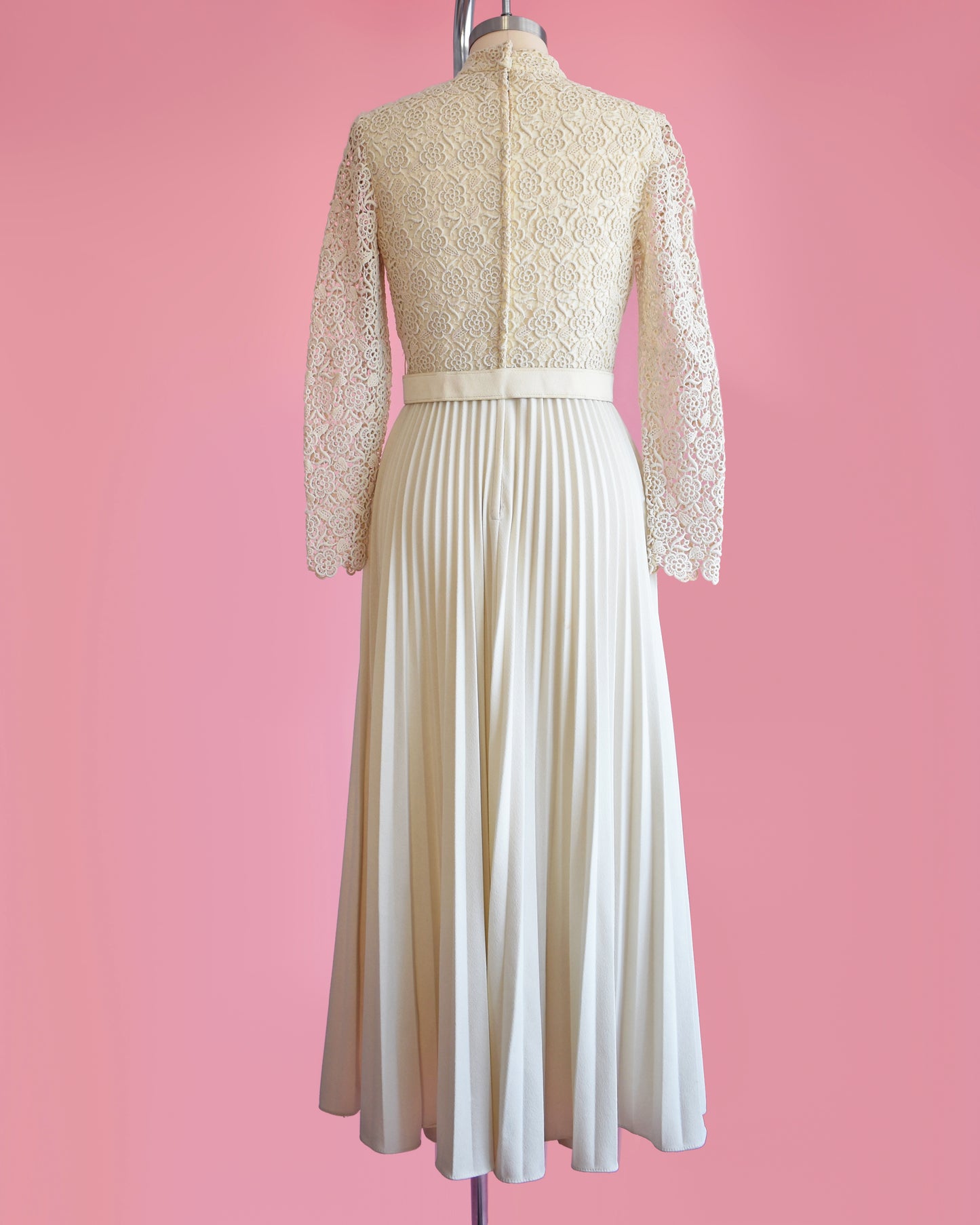 back view of a vintage 1970s crochet floral lace pleated maxi dress with matching belt
