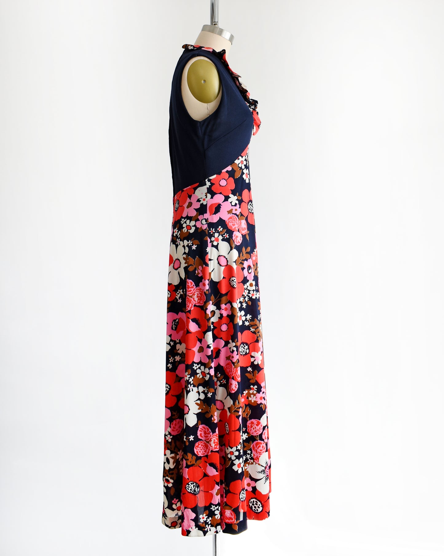 side view of a vintage 1970s navy and pink flower power maxi dress