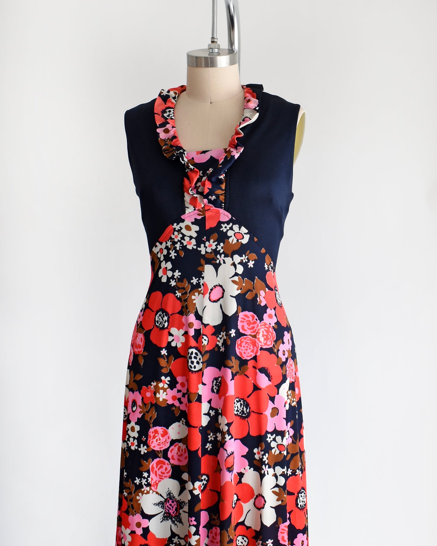 side front view of a vintage 1970s navy and pink flower power maxi dress