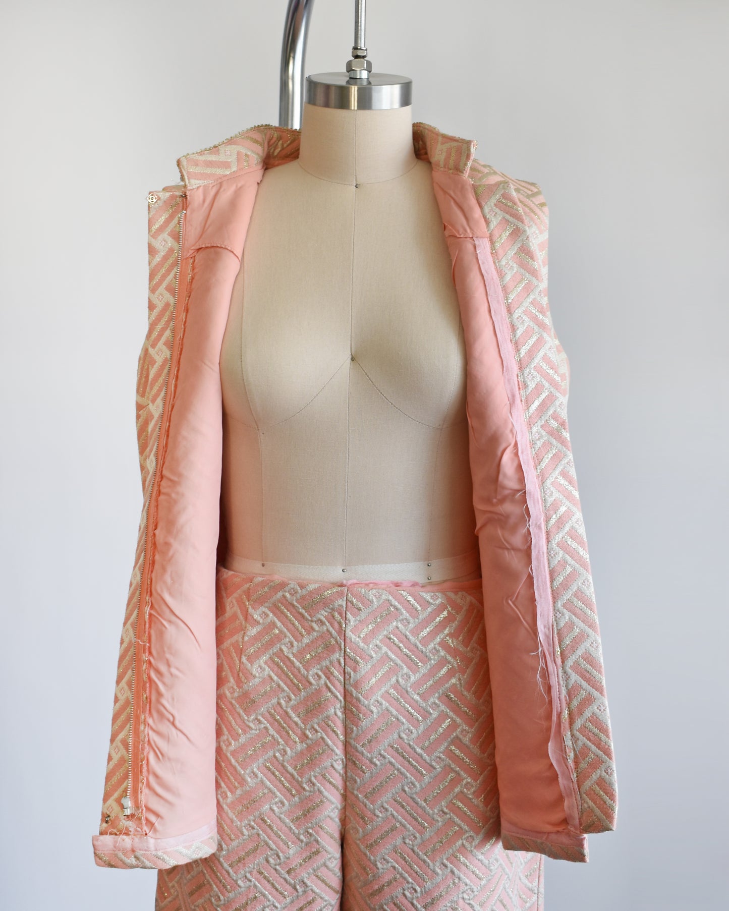 The top of the set is unzipped showing the pink lining