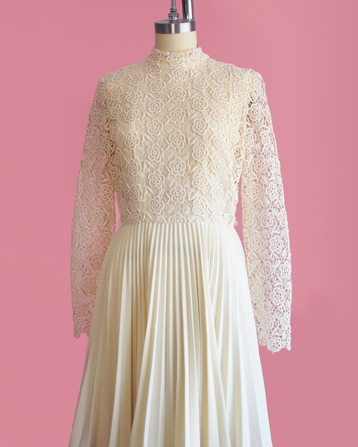 side font view of a vintage 1970s crochet floral lace pleated dress