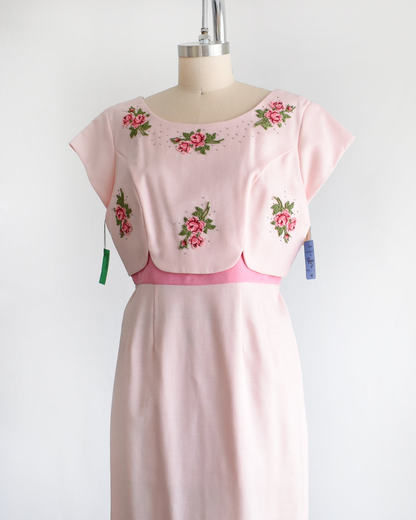 side front view of a vintage 1960s pink floral embroidered dress