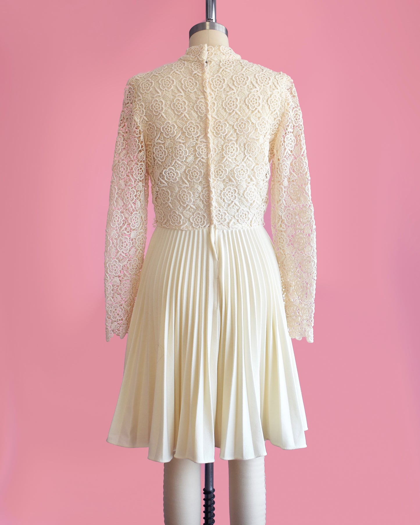back view of a vintage 1970s crochet floral lace pleated dress