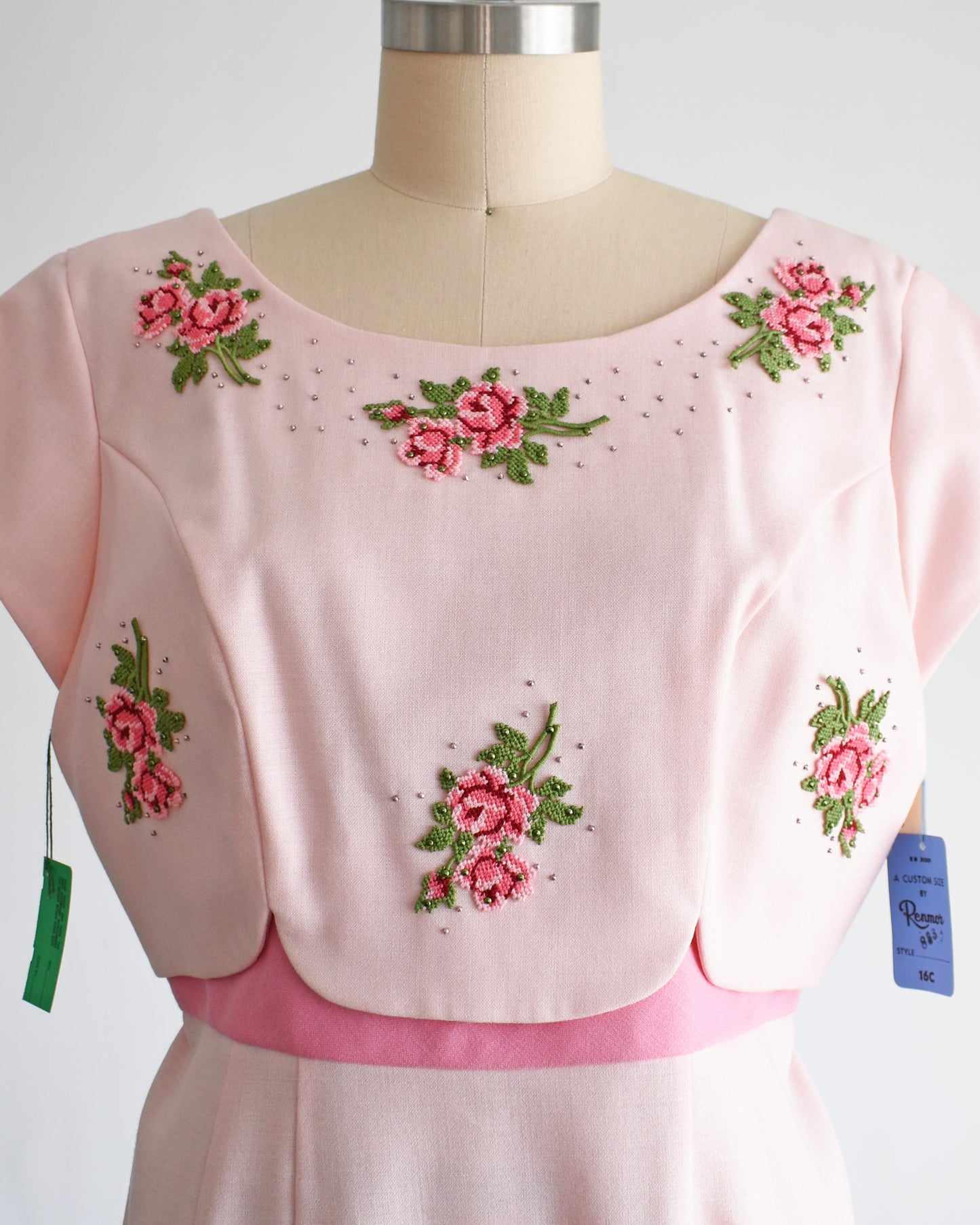 close up of the bodice with shows the needlepoint flowers and silver studs