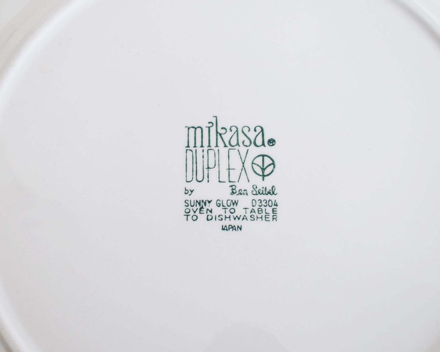 The underside of the plate which says Mikasa Duplex line “Sunny Glow” D3504 pattern, designed by Ben Seibel