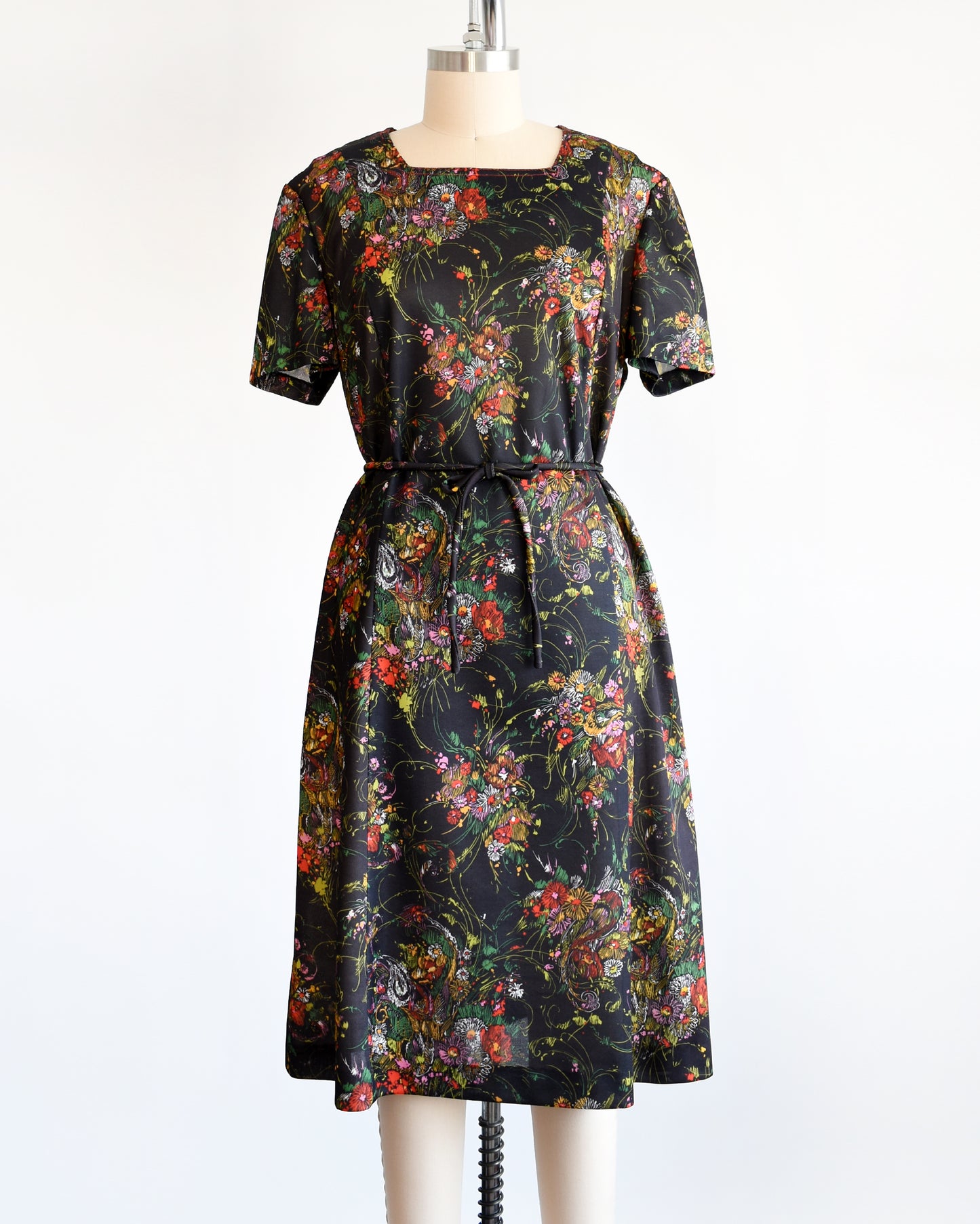 a vintage 1970s black floral dress set that comes with a dress and belt