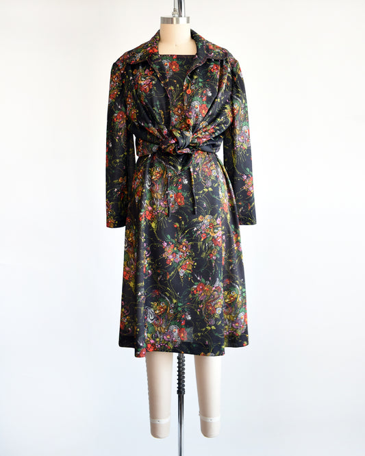 a vintage 1970s black floral dress set that comes with a dress, a matching top, and belt