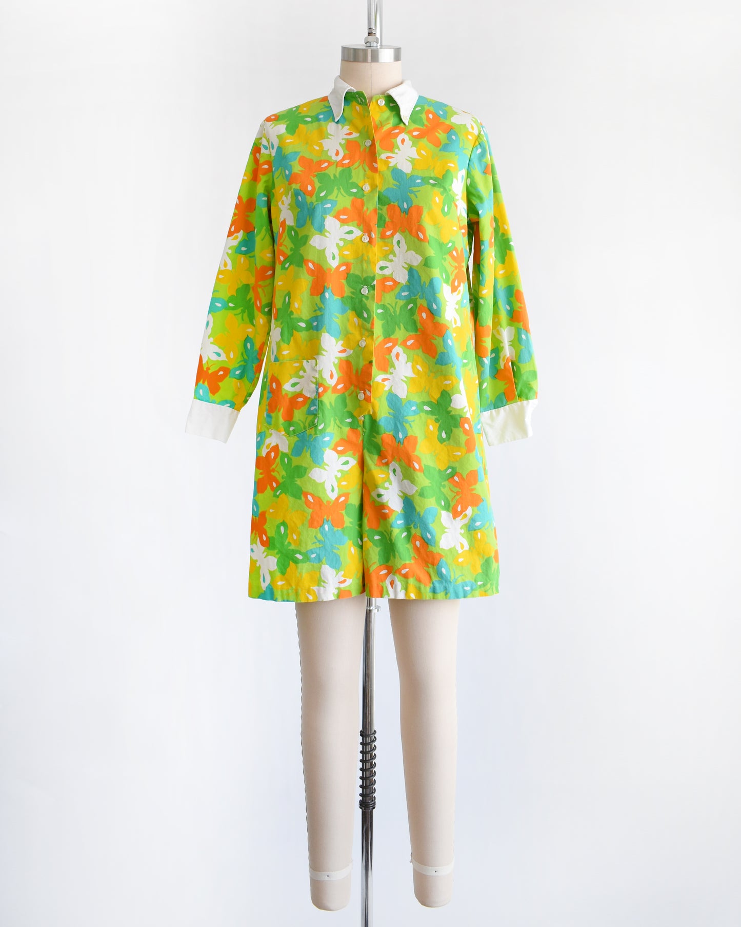 a vintage 1960s green long sleeve romper with multicolored butterfly print all over