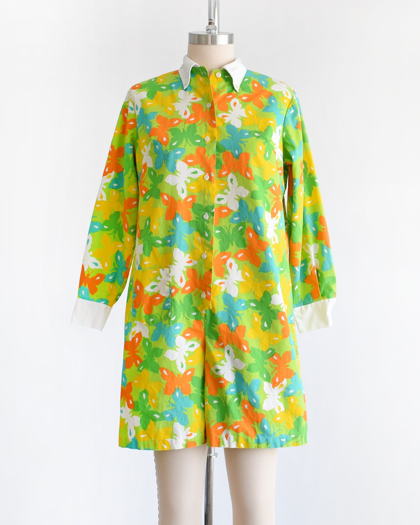 a vintage 1960s green long sleeve romper with multicolored butterfly print all over