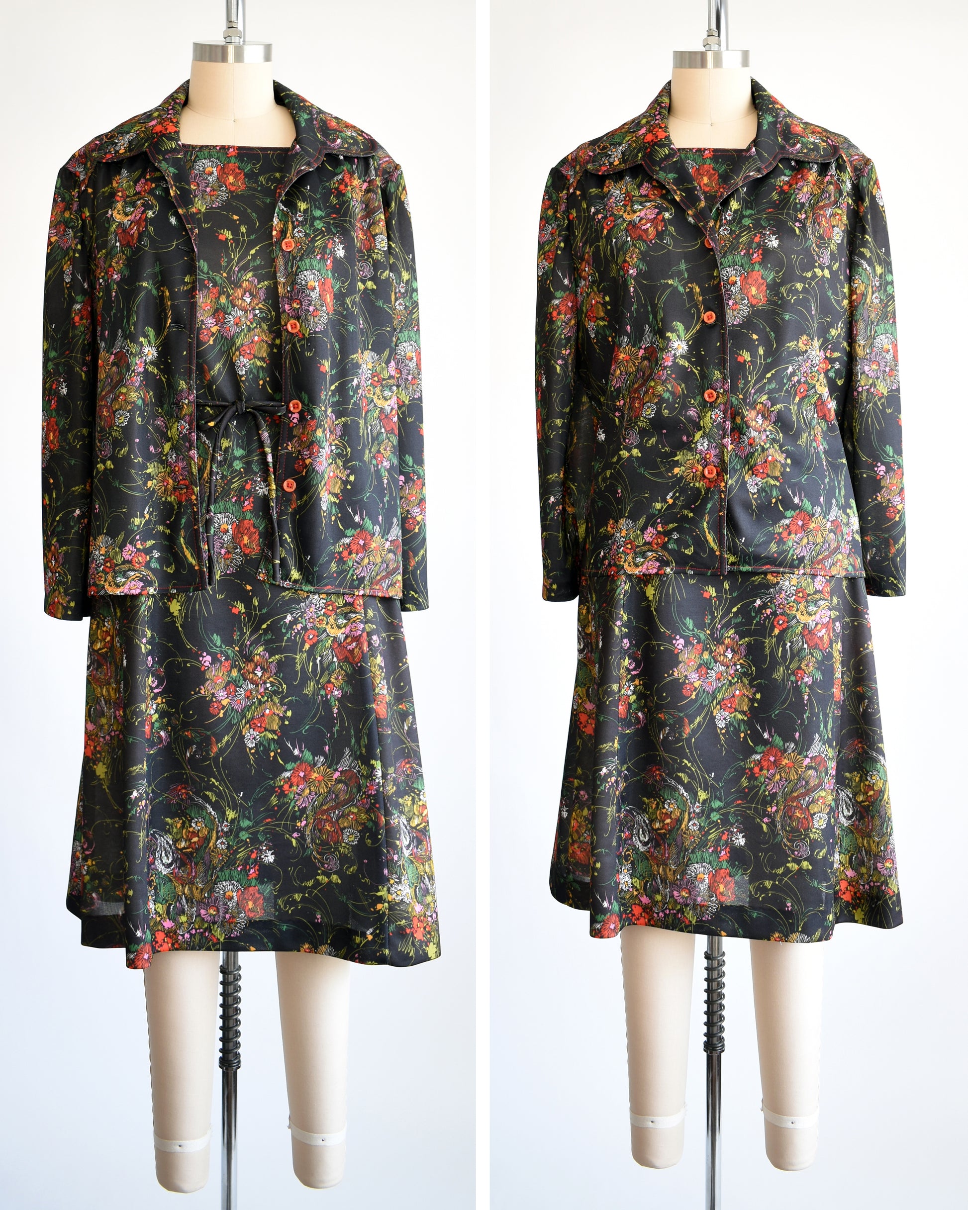 side by side front views of a vintage 1970s black floral dress set that comes with a dress, a matching top, and belt. the left the top is unbuttoned and the right shows the top buttoned