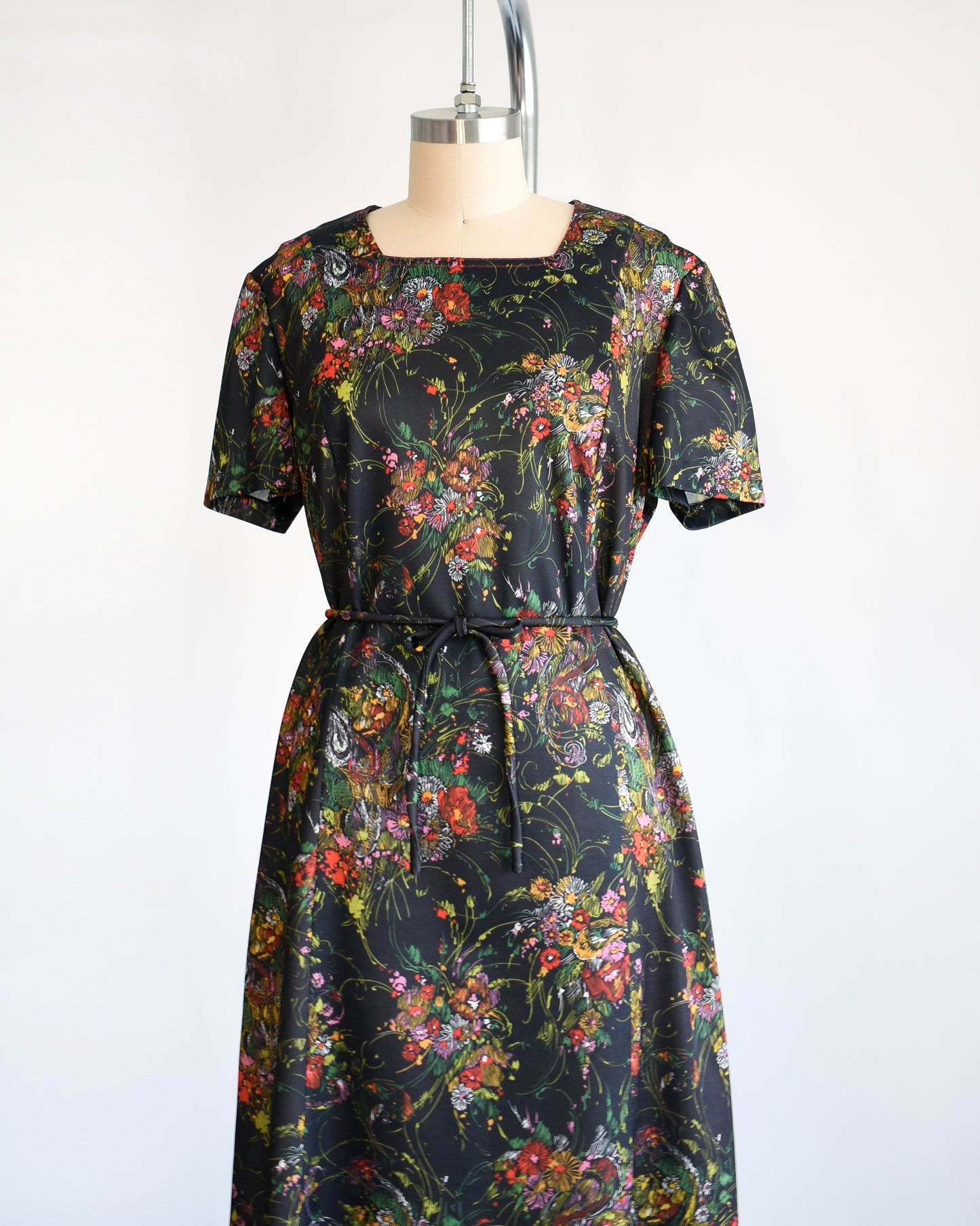 a vintage 1970s black floral dress set that comes with a dress and belt