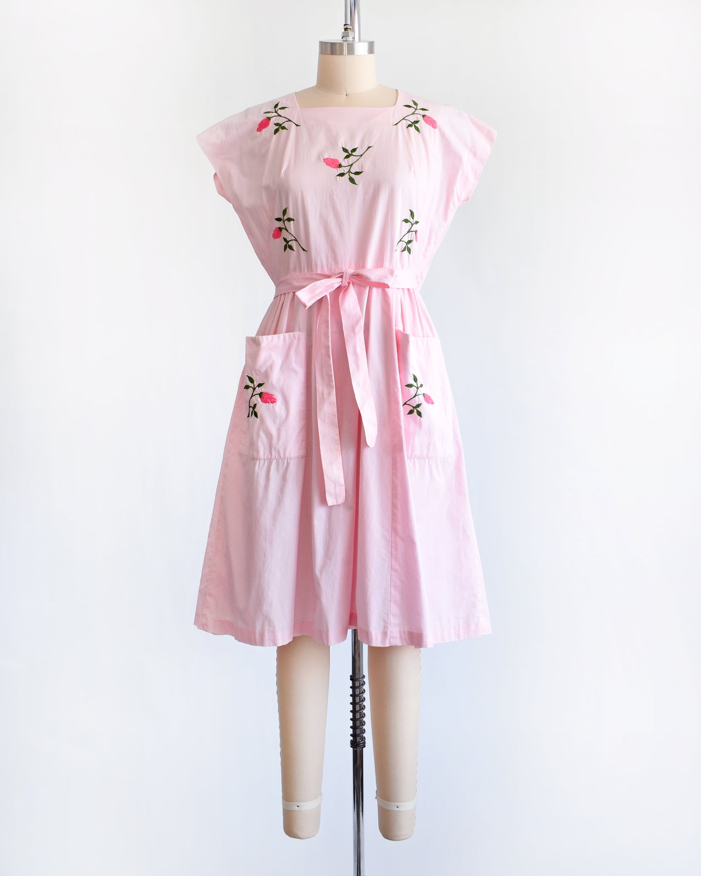 a vintage 1950s pink floral wrap dress by Swirl