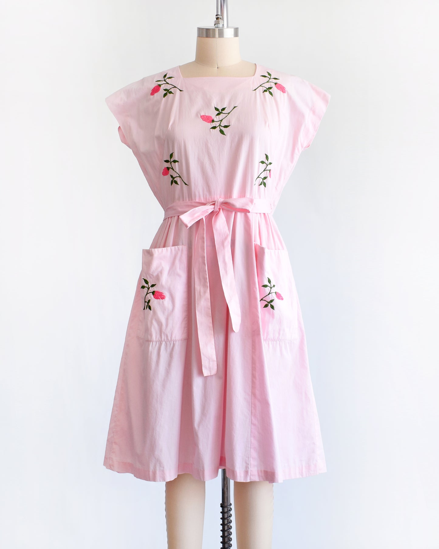 a vintage 1950s pink floral wrap dress by Swirl