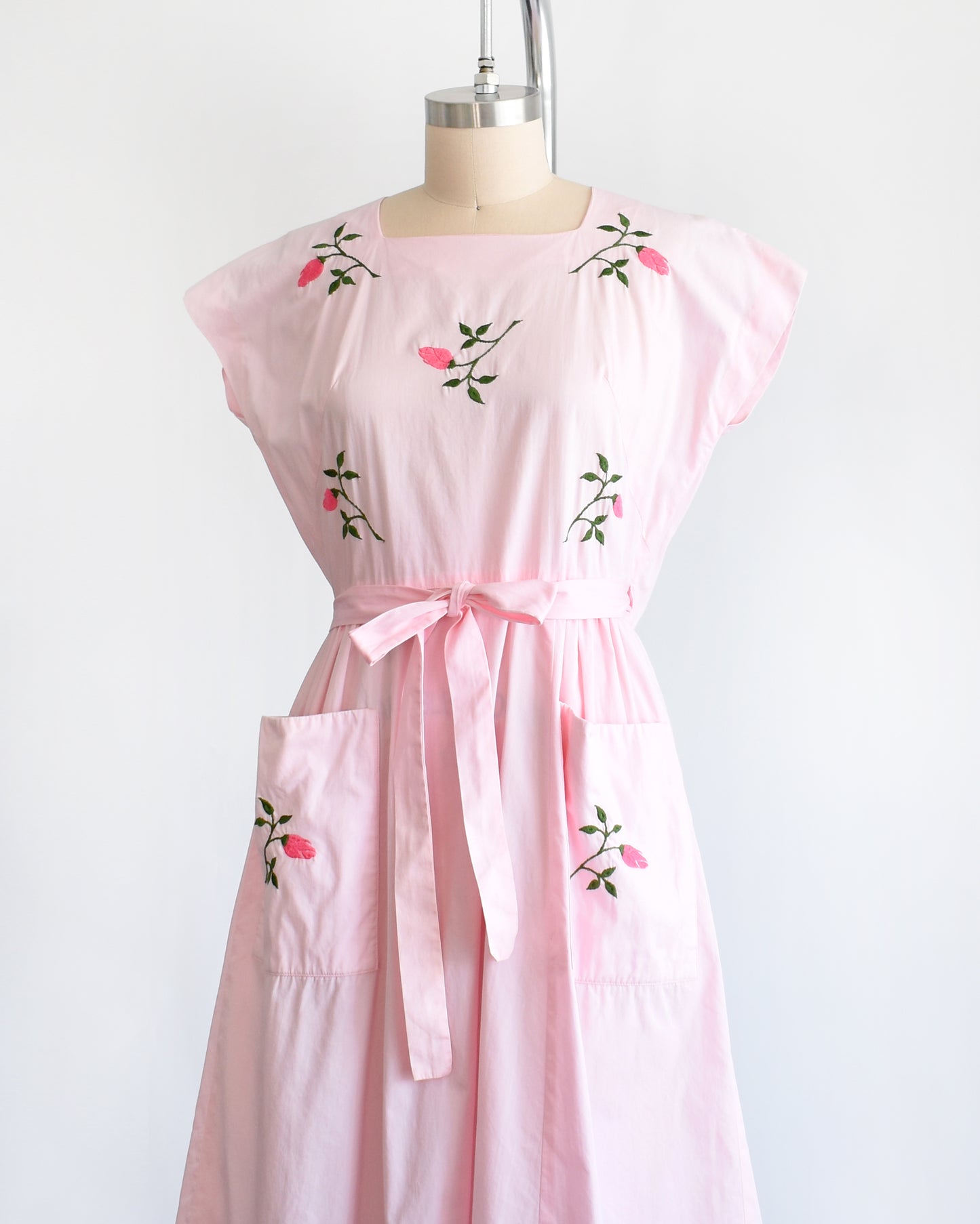 side front view of a vintage 1950s pink floral wrap dress by Swirl