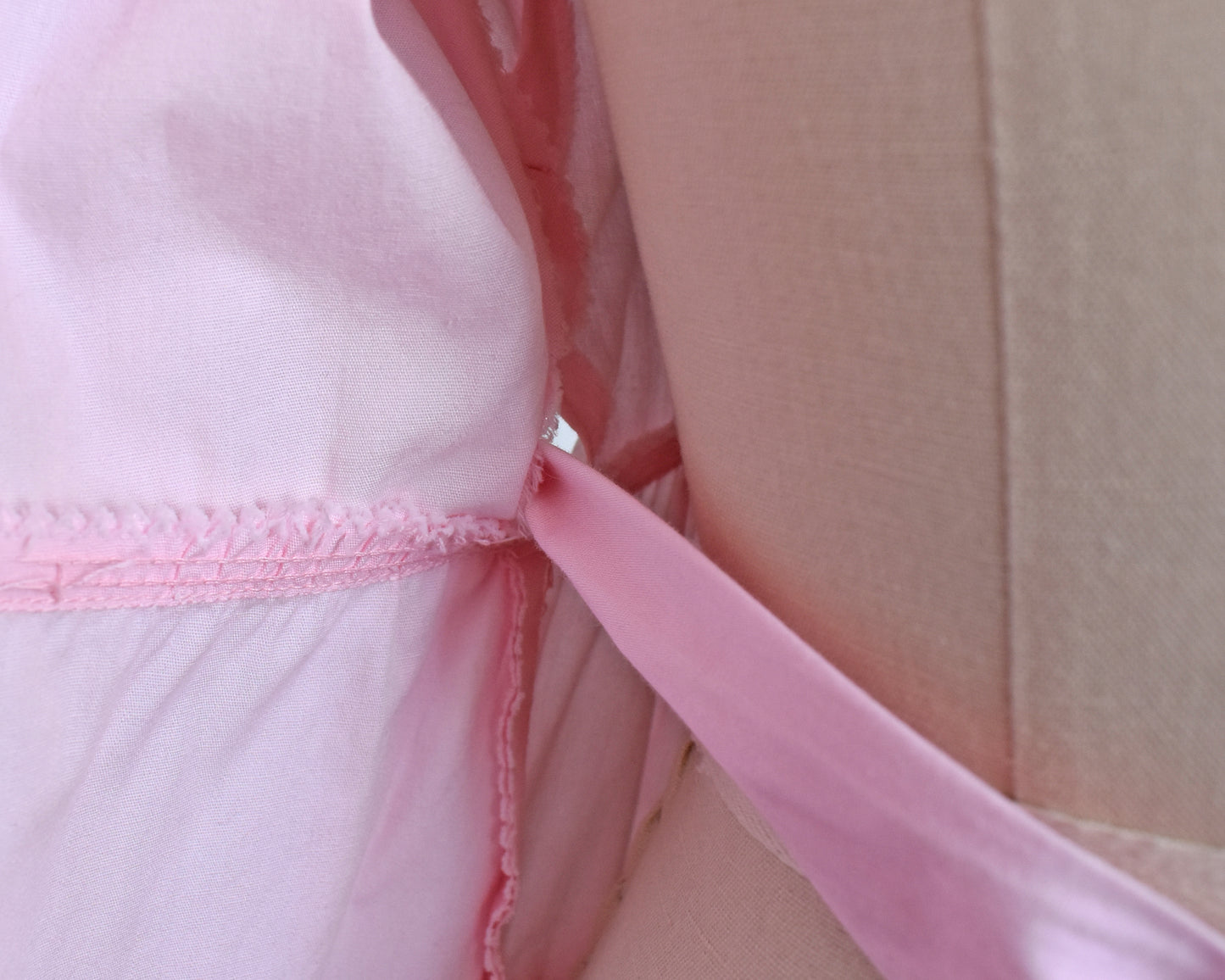 close up of one of the ties and seam opening on the inside of the dress