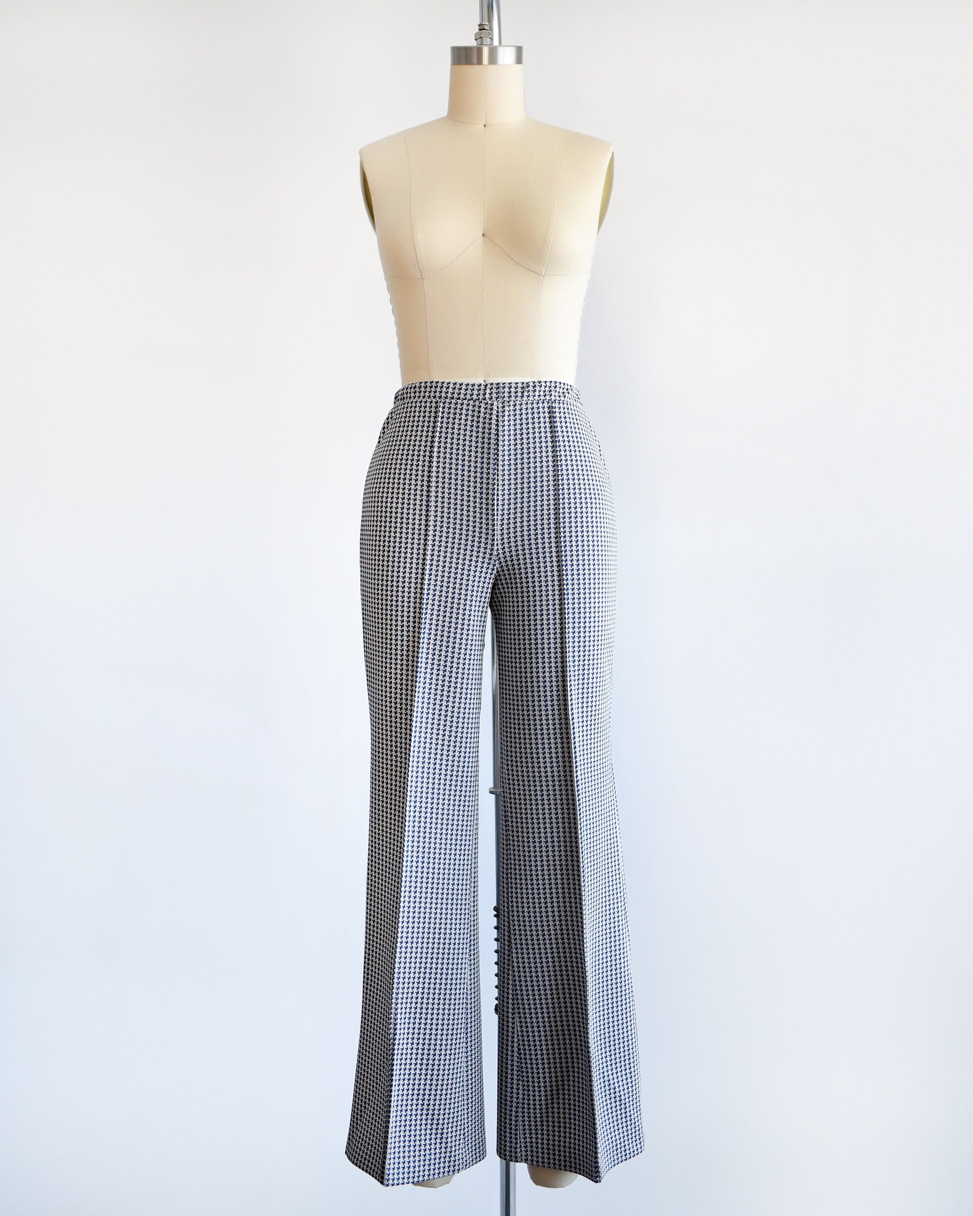 a pair of vintage 1970s wide leg pants with houndstooth print